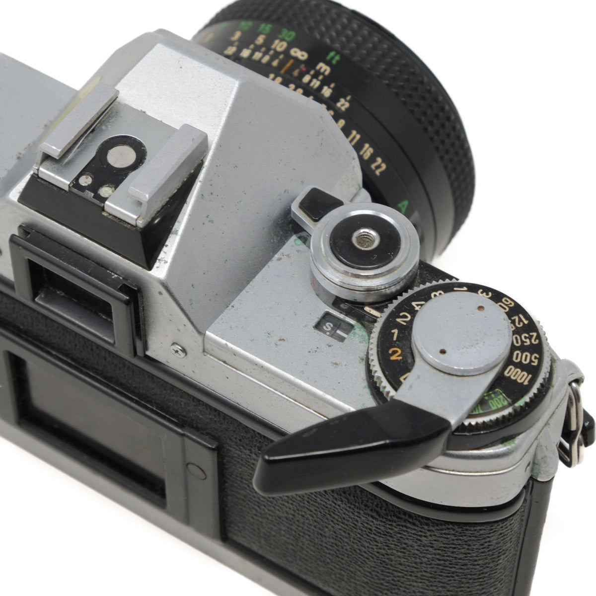 Close-up of a vintage camera with detailed controls on a white background
