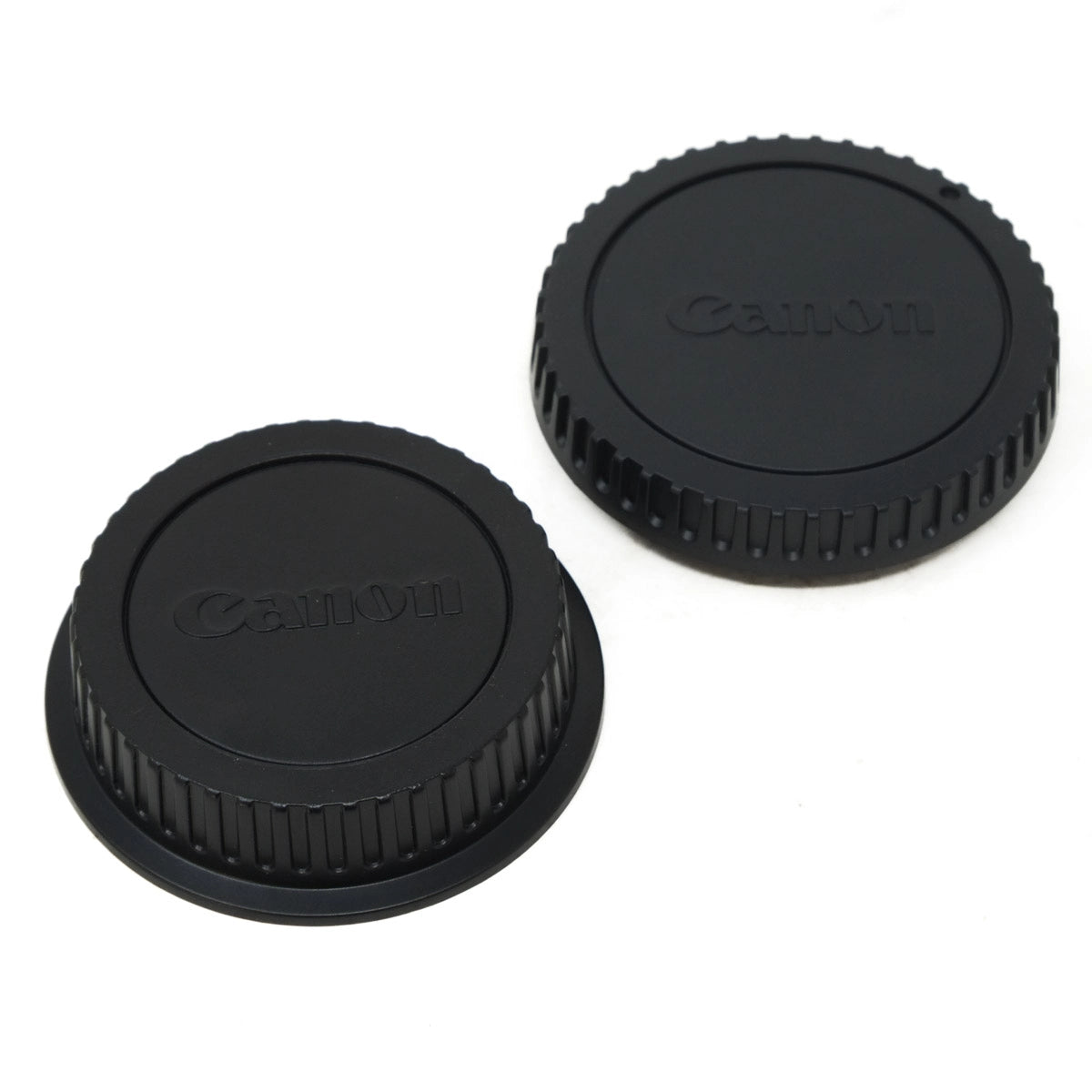 Two Canon camera lens caps on a white background