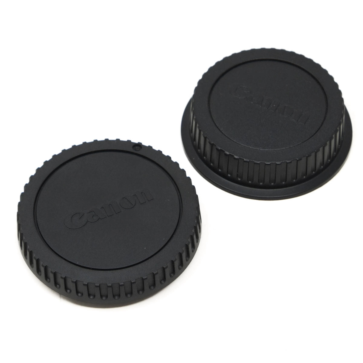 Two Canon lens caps on a white background