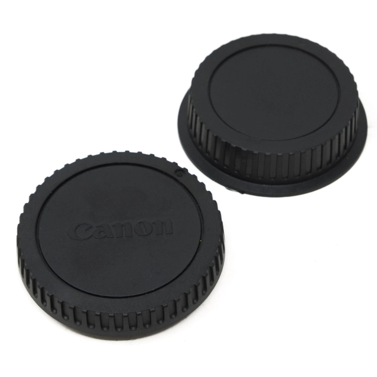 Two black camera lens caps with 'Canon' branding on a white background