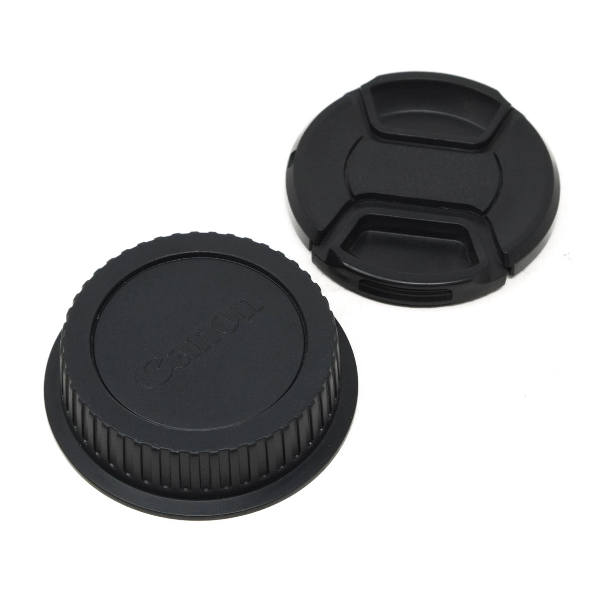 Two black camera lens caps on a white background
