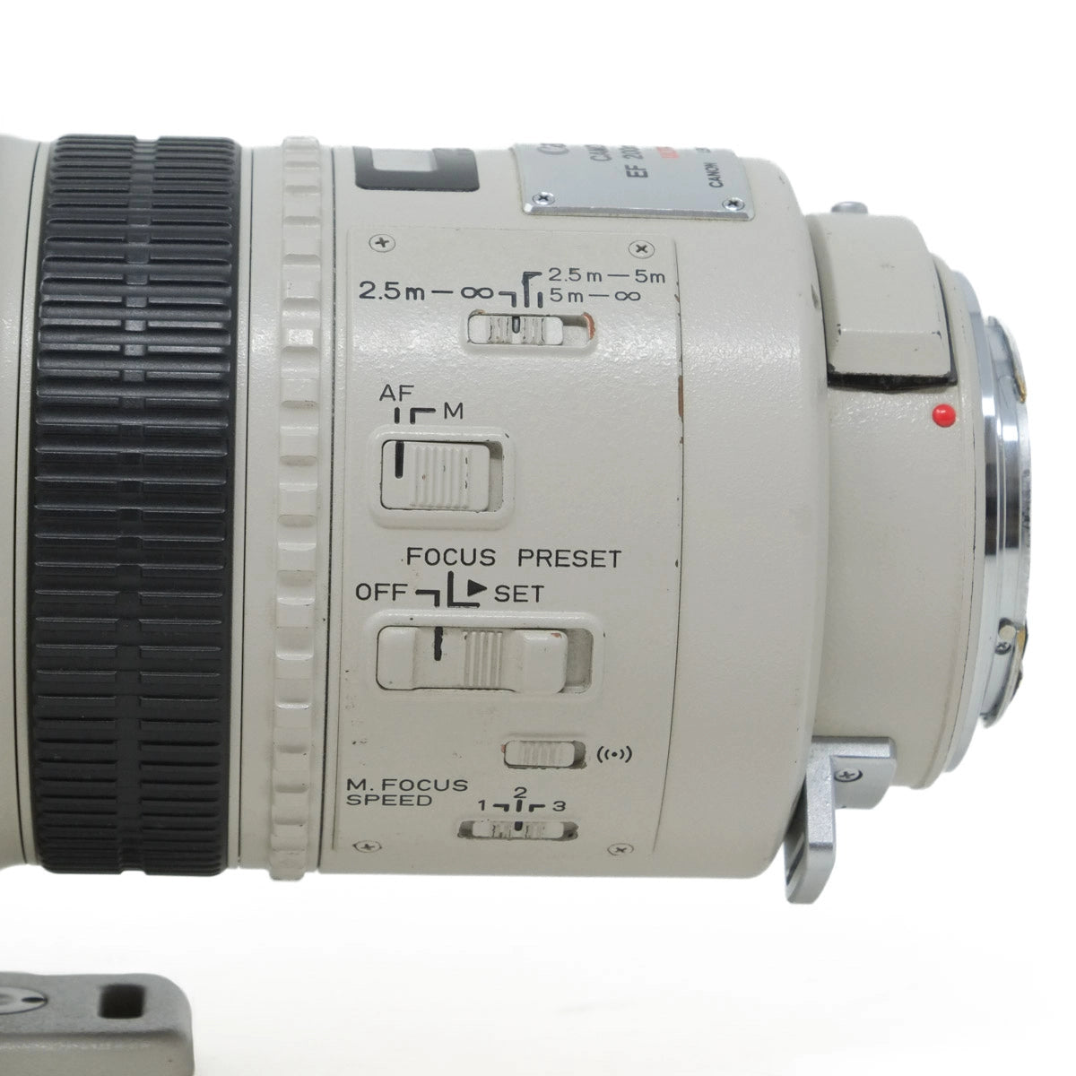 Close-up of a camera lens with control buttons on a white background