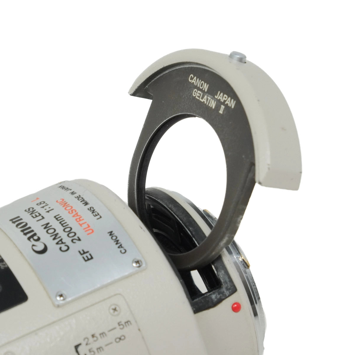 Close-up of a Canon camera lens with a white background