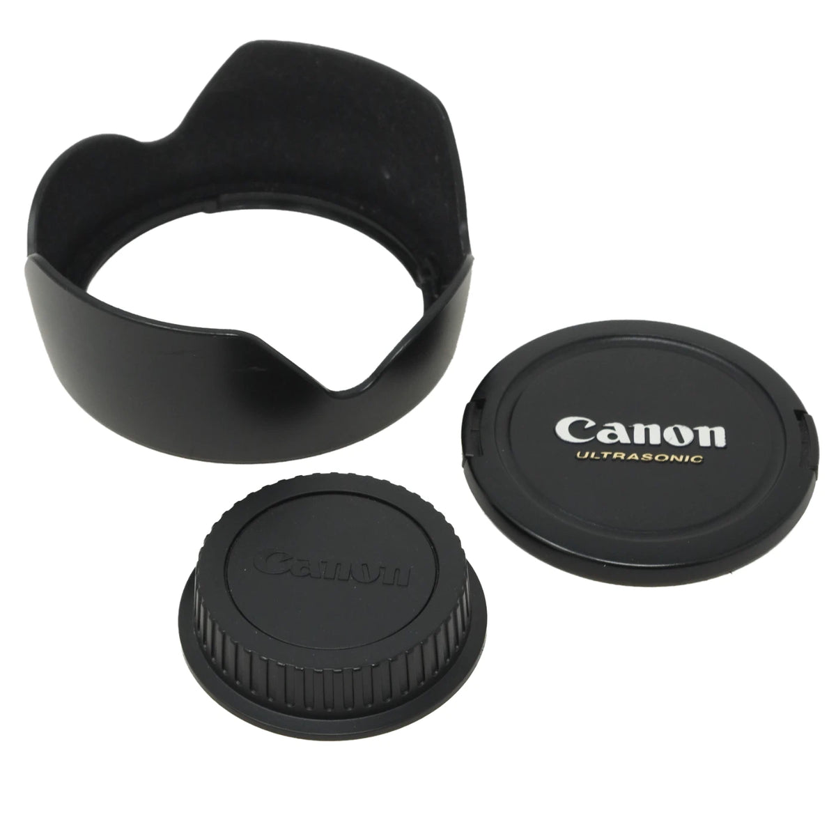 Black Canon Ultrasonic lens cap and lens hood set on a white background, showing both the flat lens cover and the ribbed protective cap alongside the lens hood.