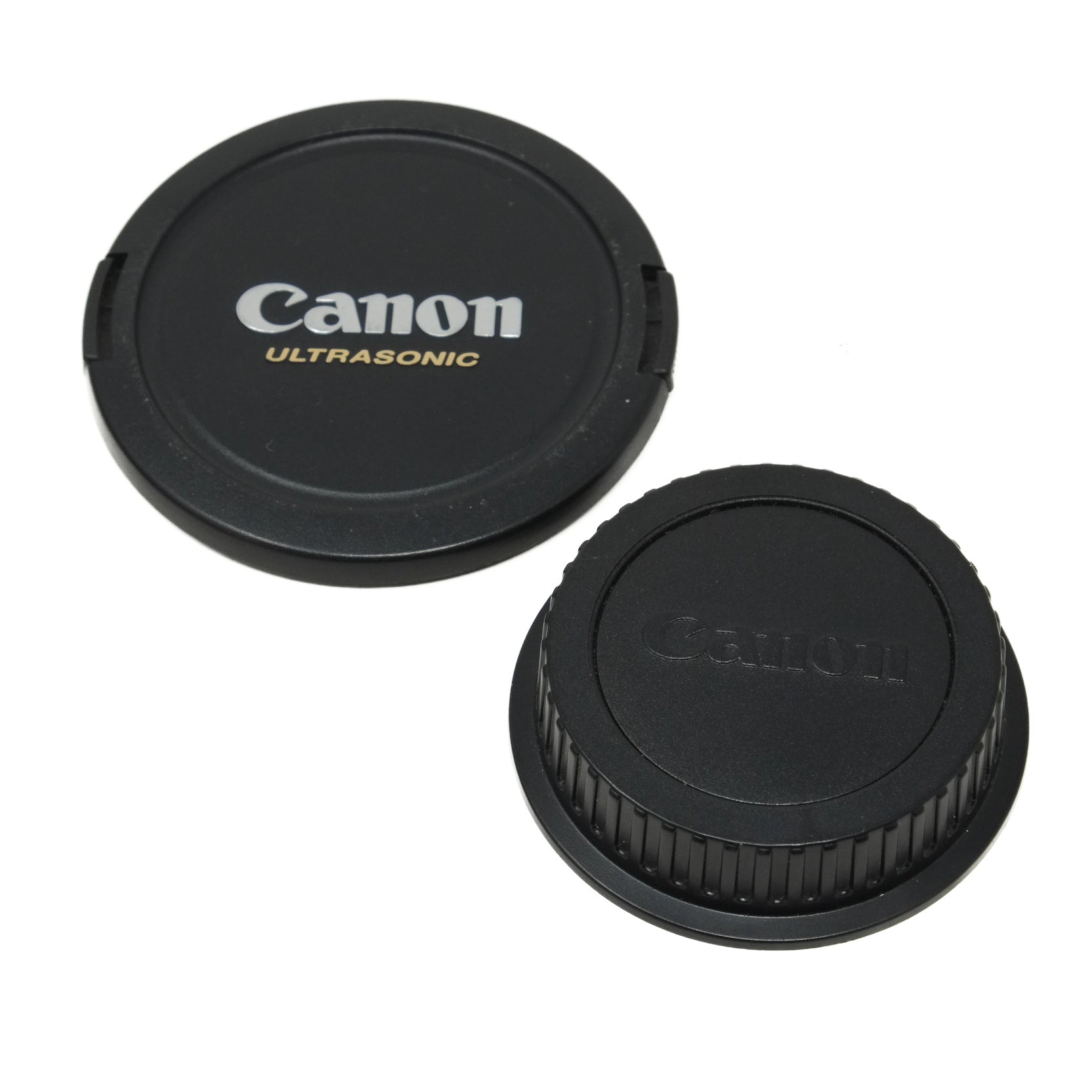 Canon lens cap and body cap on a white background
