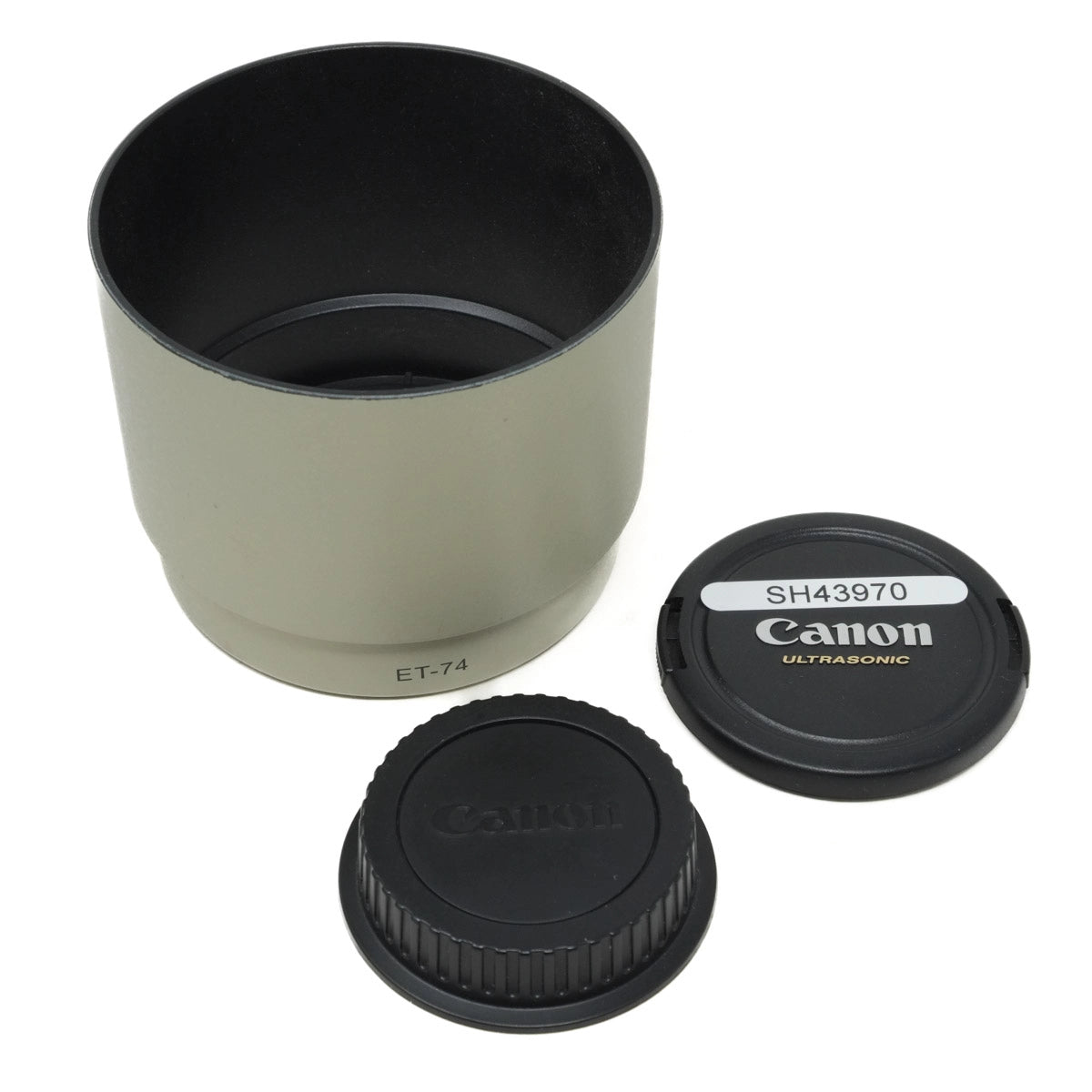 Camera lens hood and caps with Canon branding on a white background