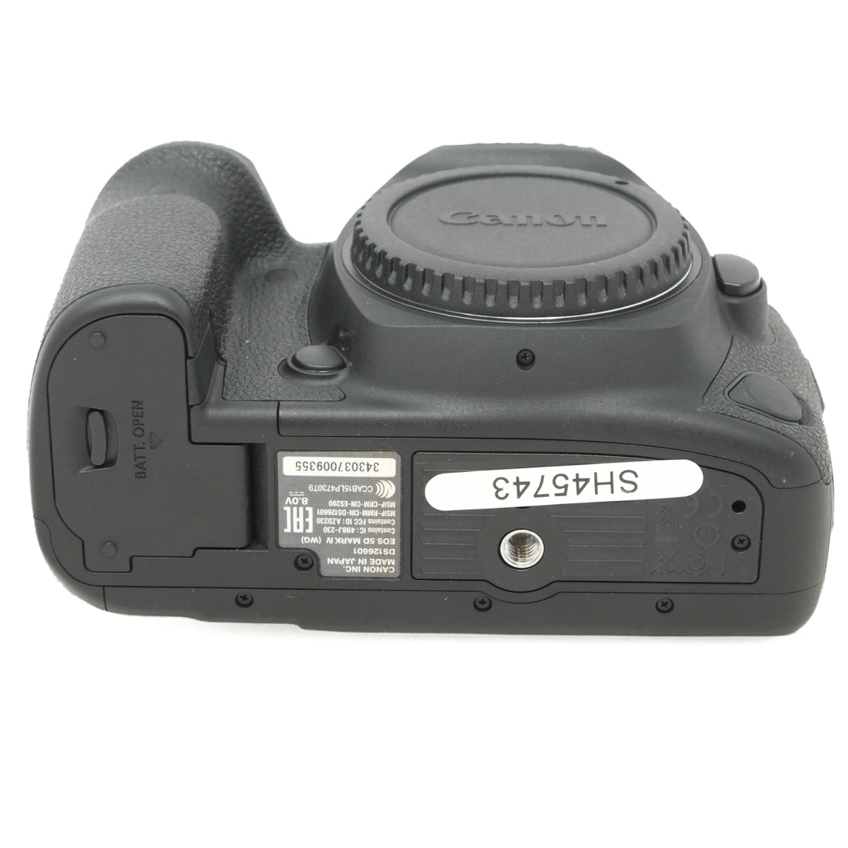 Canon DSLR camera body rear view showing the battery compartment, lens cap, and product labels on a white background.