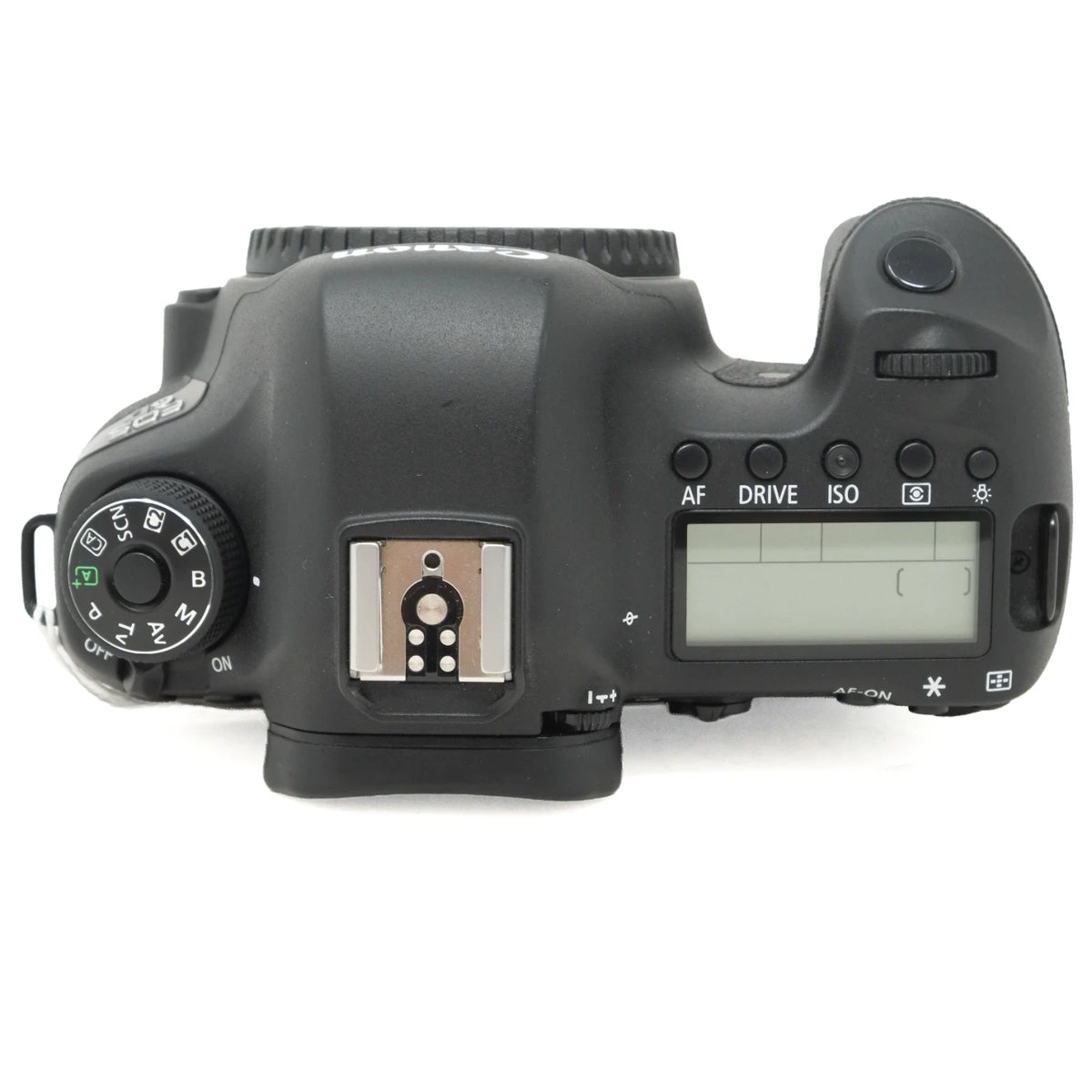 The top view of a black DSLR camera body, showing the mode dial, hot shoe, screen, and control buttons, photographed on a white background.