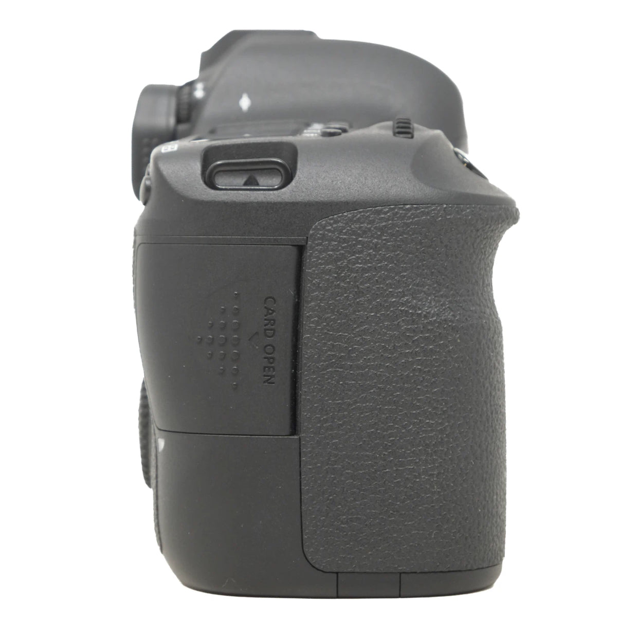 A close-up side view of a black DSLR camera body grip, showing the textured rubberized handle, card open button, and control buttons against a plain white background.