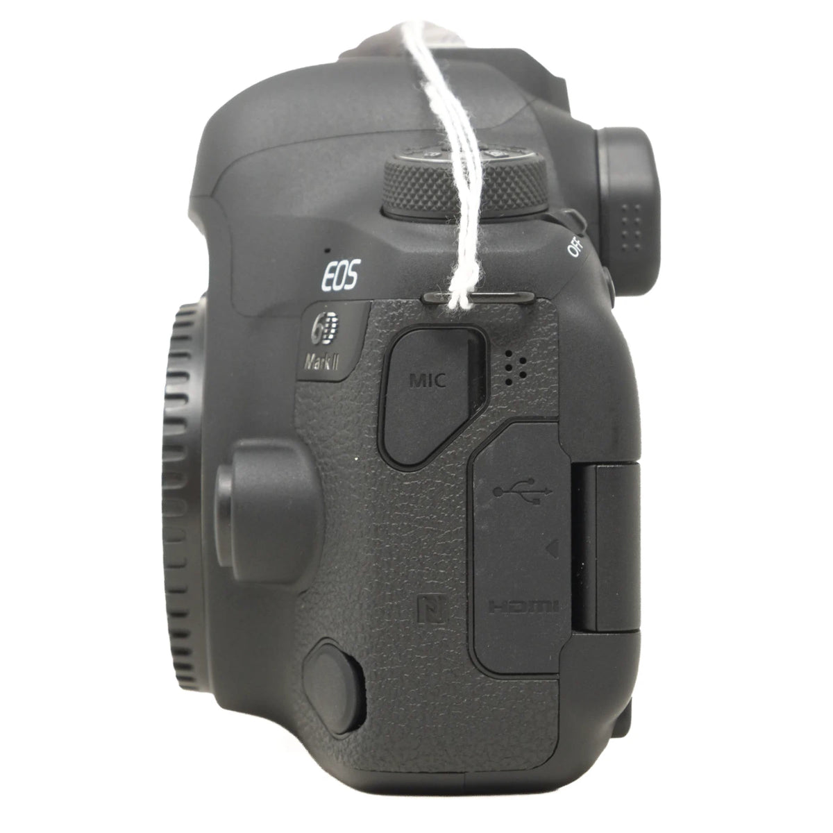 A Canon EOS DSLR camera body, shown from the rear/top side view, featuring textured grip buttons and ports like MIC and HDMI, with a white string tag attached.