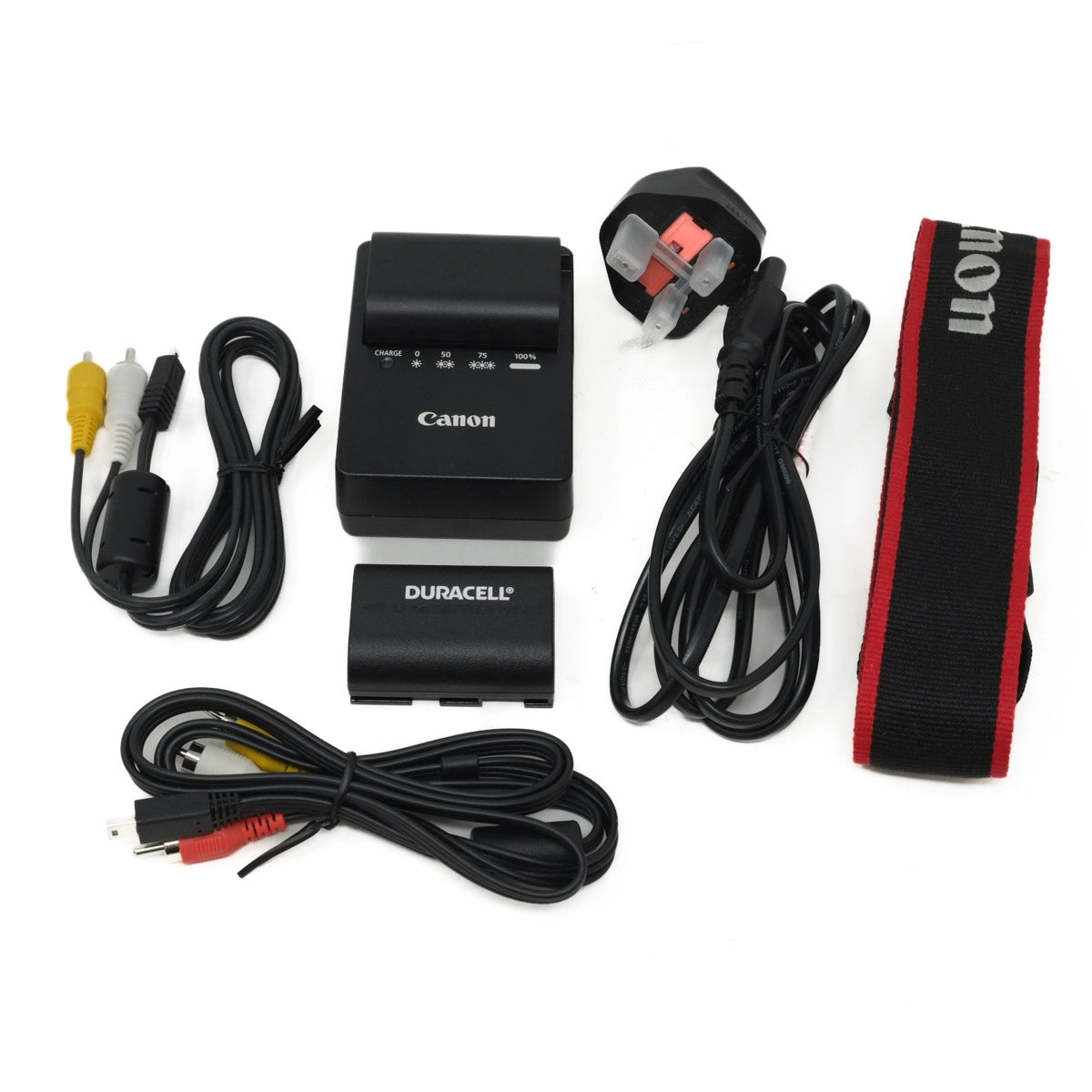 Collection of electronic accessories including a Canon camera charger, Duracell battery, and cables on a white background.