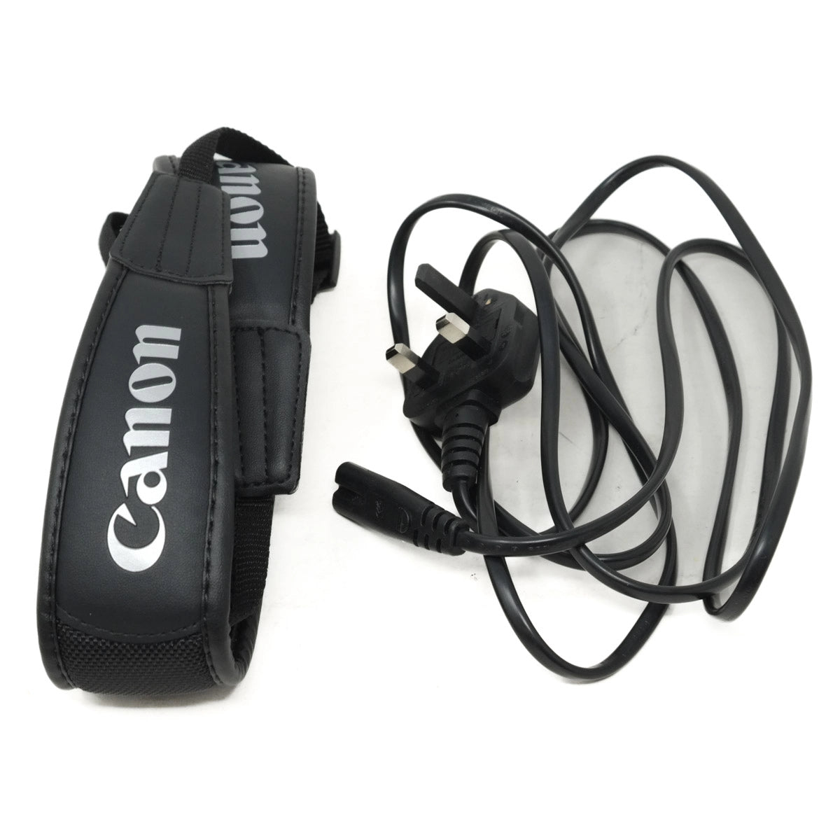 Canon camera strap and power cord on a white background