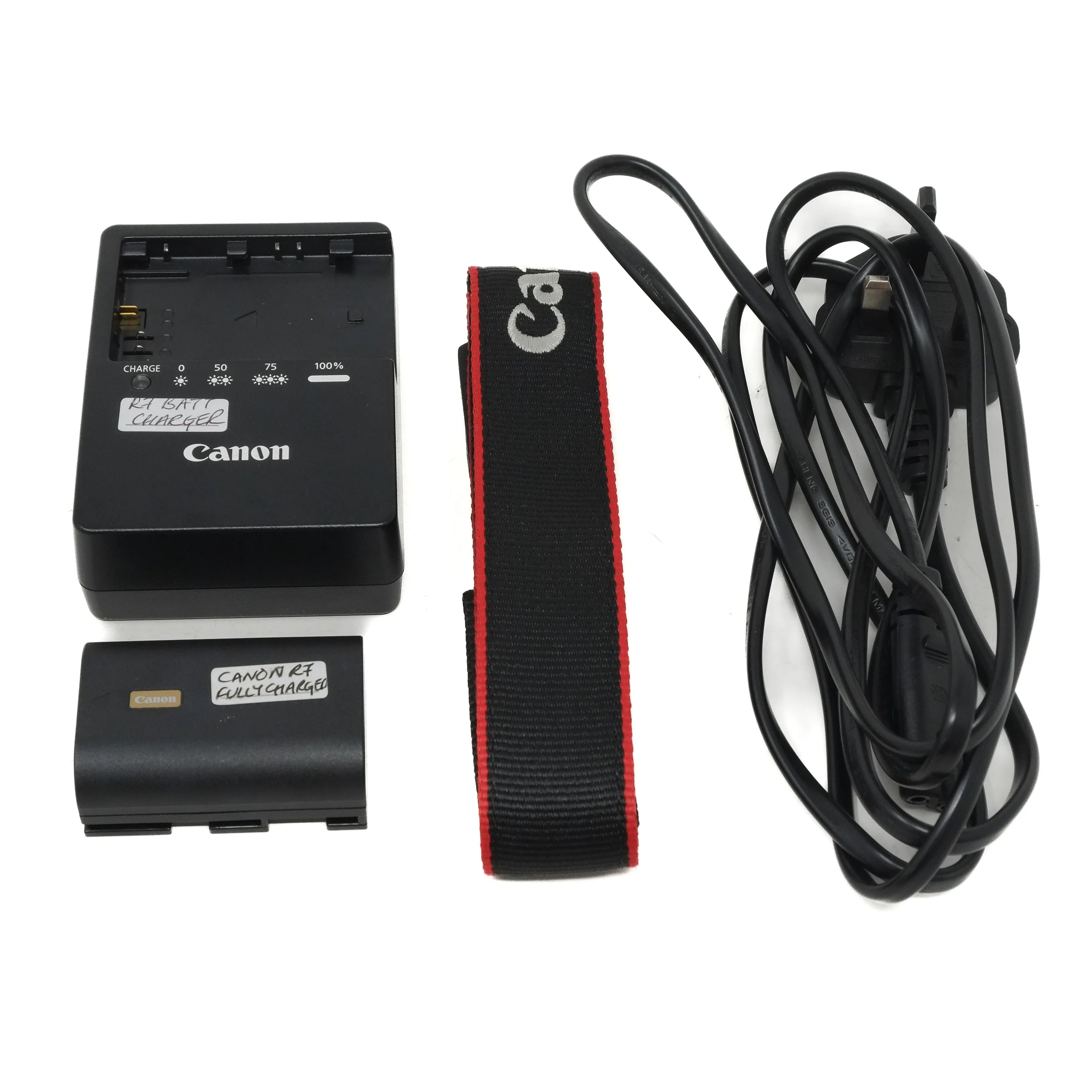 Canon camera battery, charger, strap, and cable on a white background
