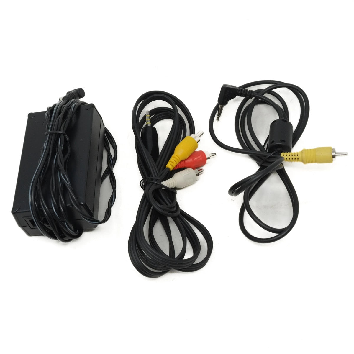 Set of electronic components including a power adapter, audio/video cables on a white background.