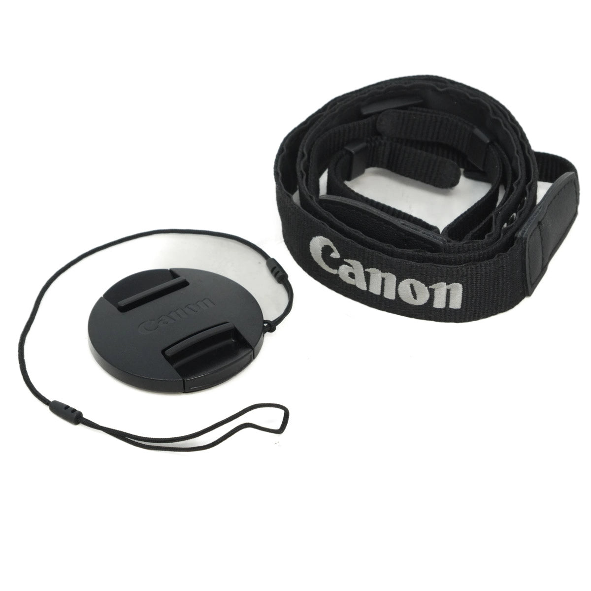 Canon camera lens cap and strap on a white background