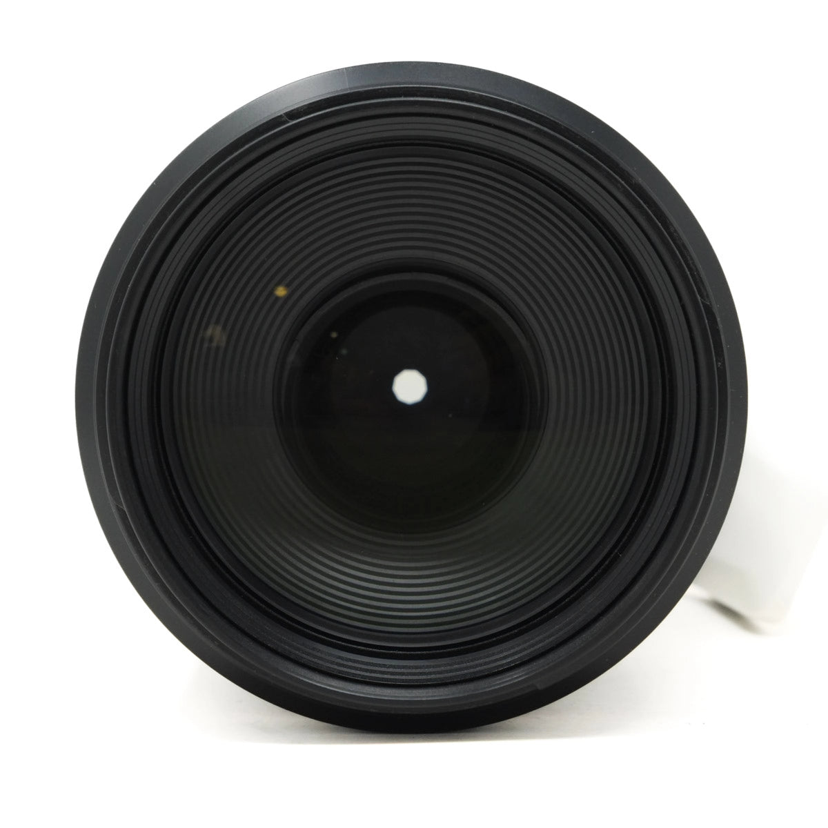 Close-up of a black camera lens on a white background