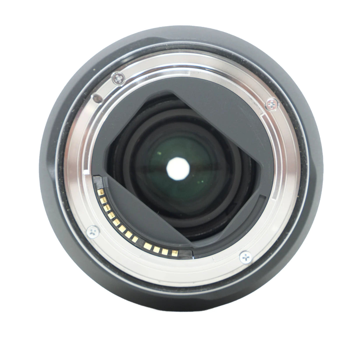 A close-up studio shot of a camera lens mount or lens back, showing the internal glass elements, metallic ring, and small gold contact pins, isolated on a white background.