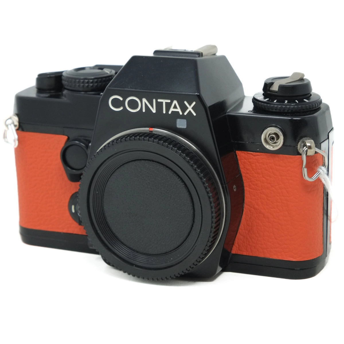 Contax camera with orange body and black accents on a white background