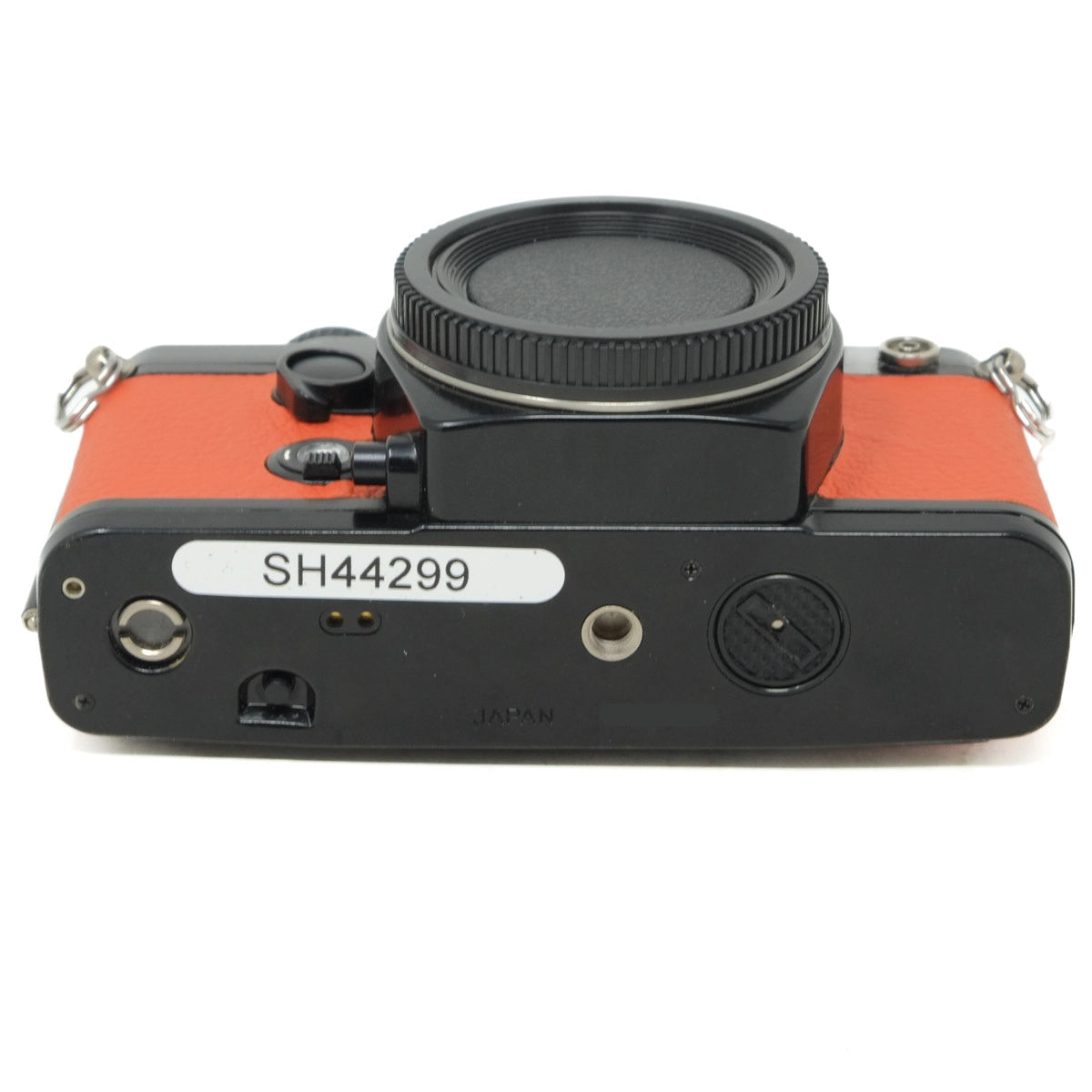 Camera body with orange and black design on a white background