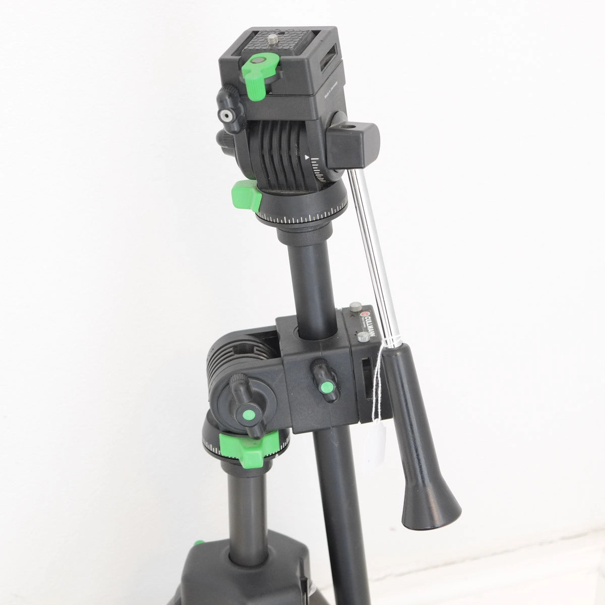 Tripod with a camera mount on a white background