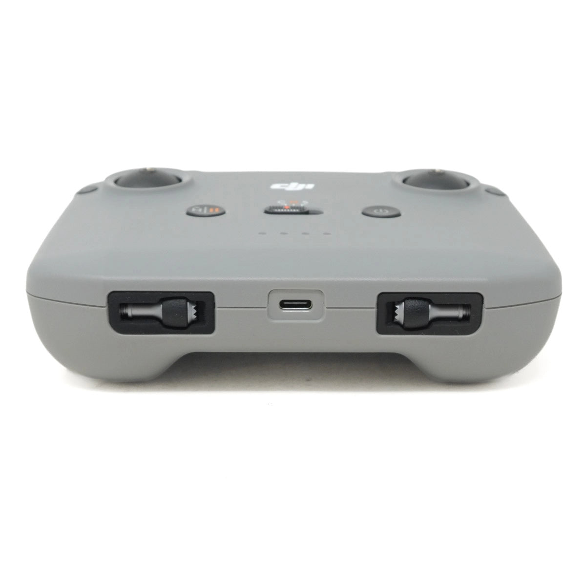 Gray remote control device with DJI logo on a white background