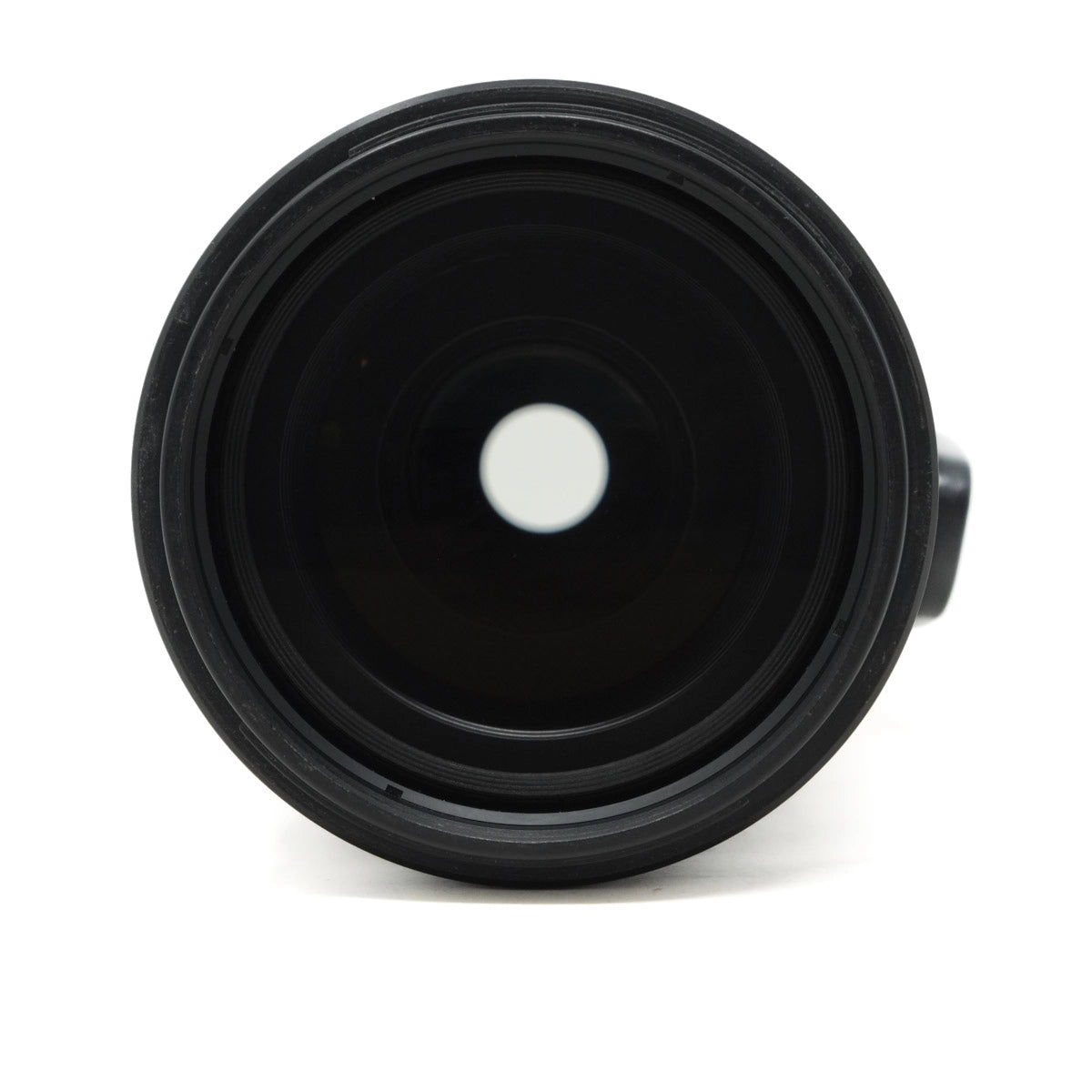 Close-up of a black camera lens on a white background