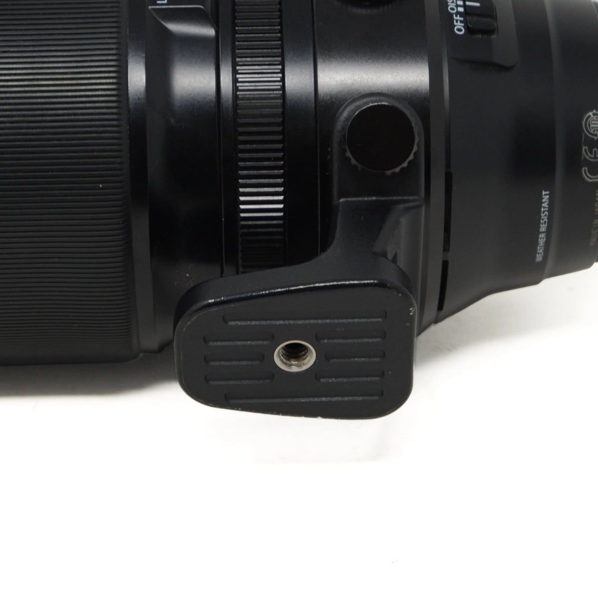 Close-up of a black camera lens on a white background