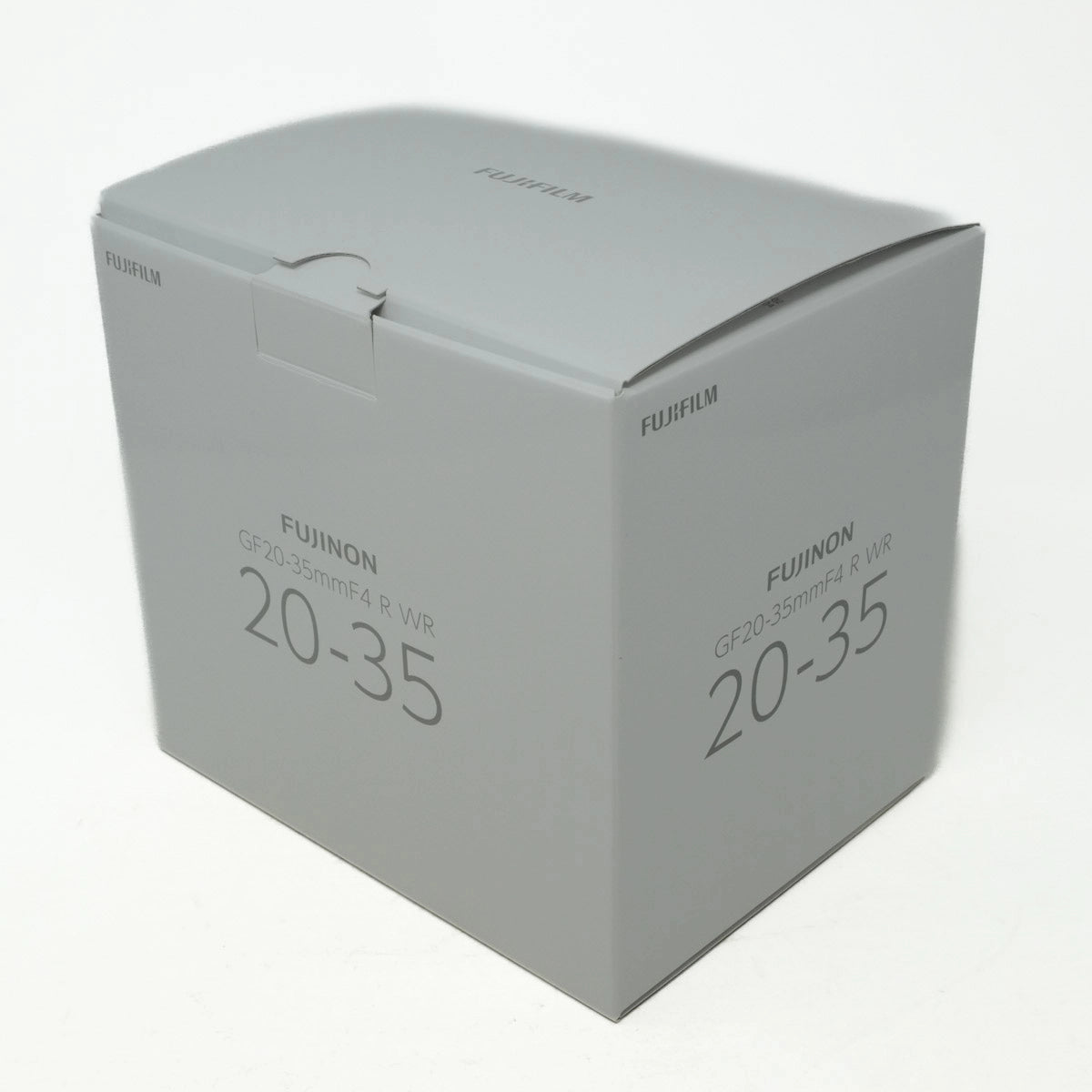 Fujifilm camera lens packaging box on a white background