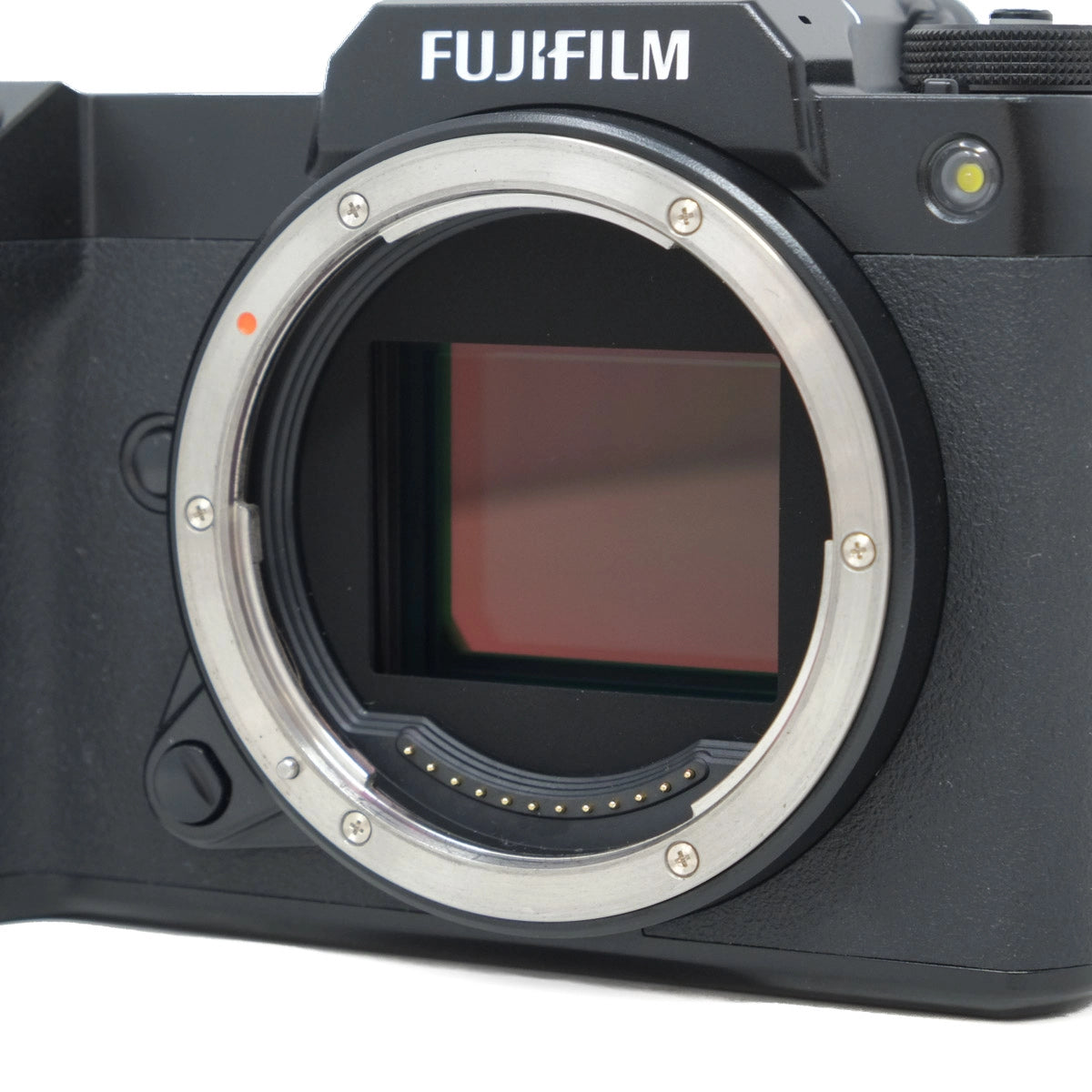 Close-up of a Fujifilm camera body with sensor visible on a white background