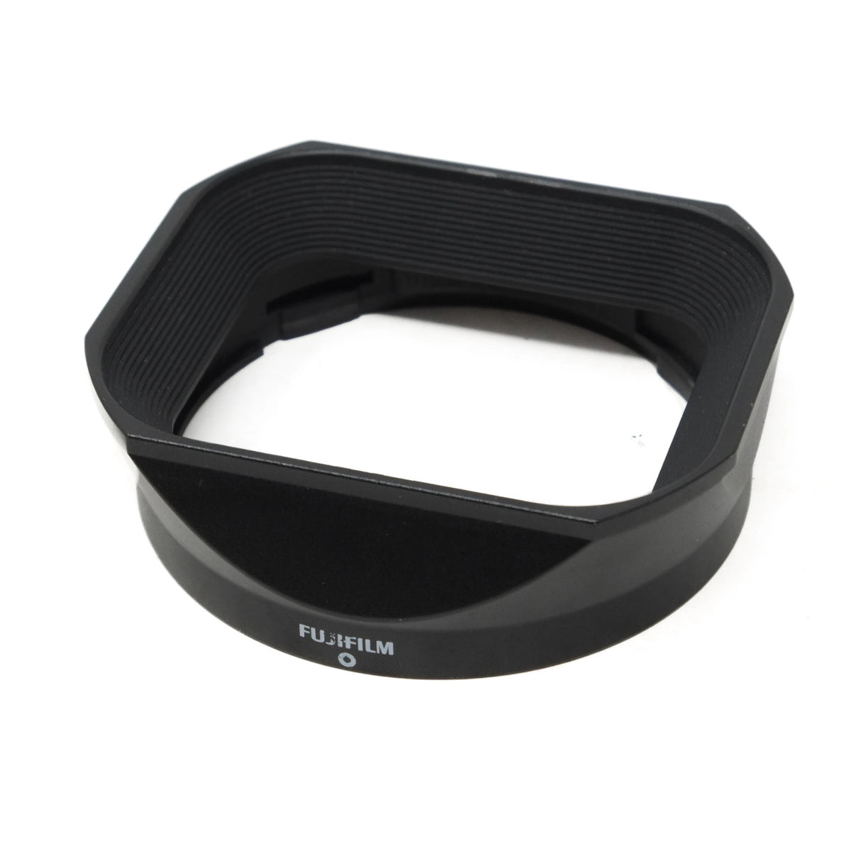 Black Fujifilm lens hood on a white background