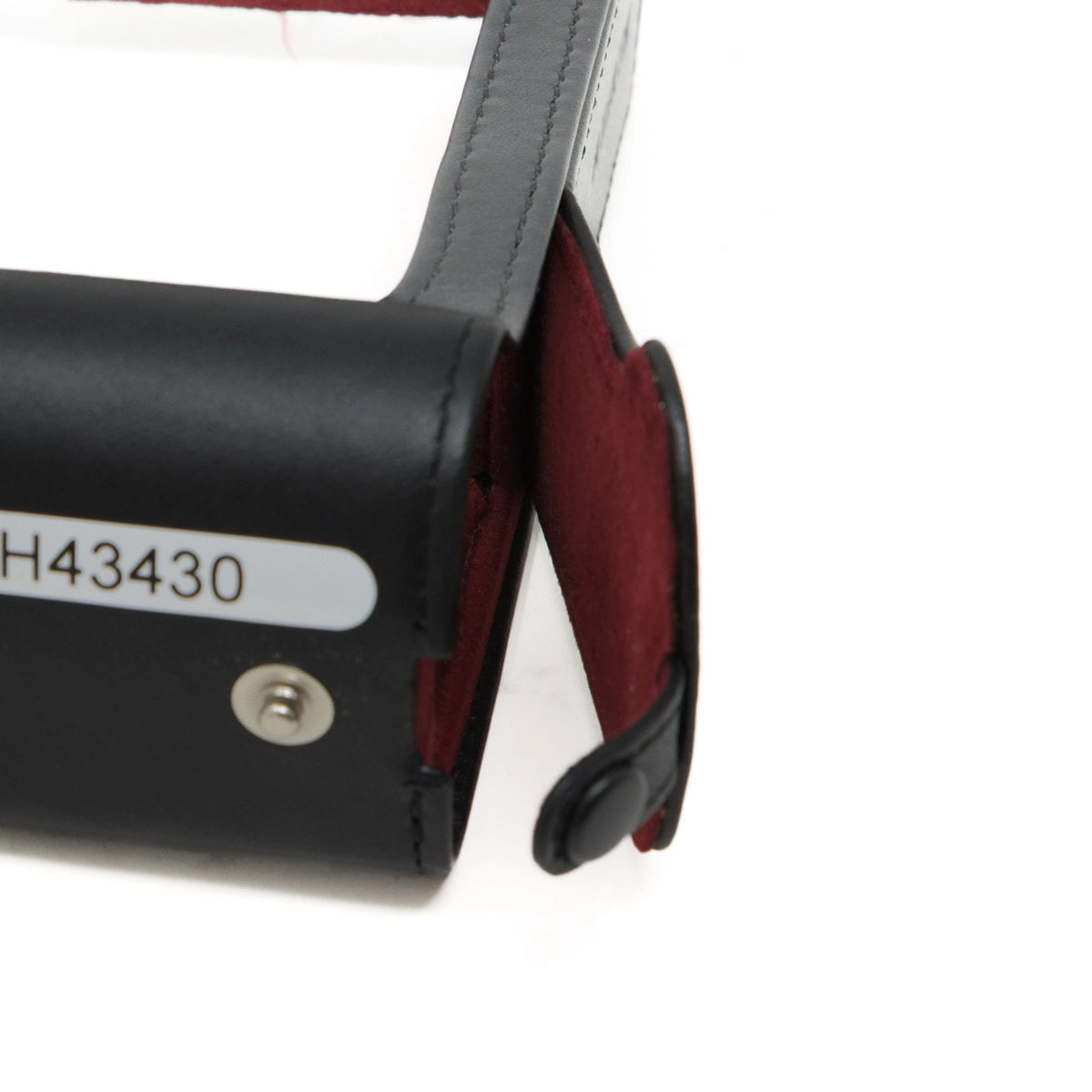 Black leather hard case with red interior on a white background