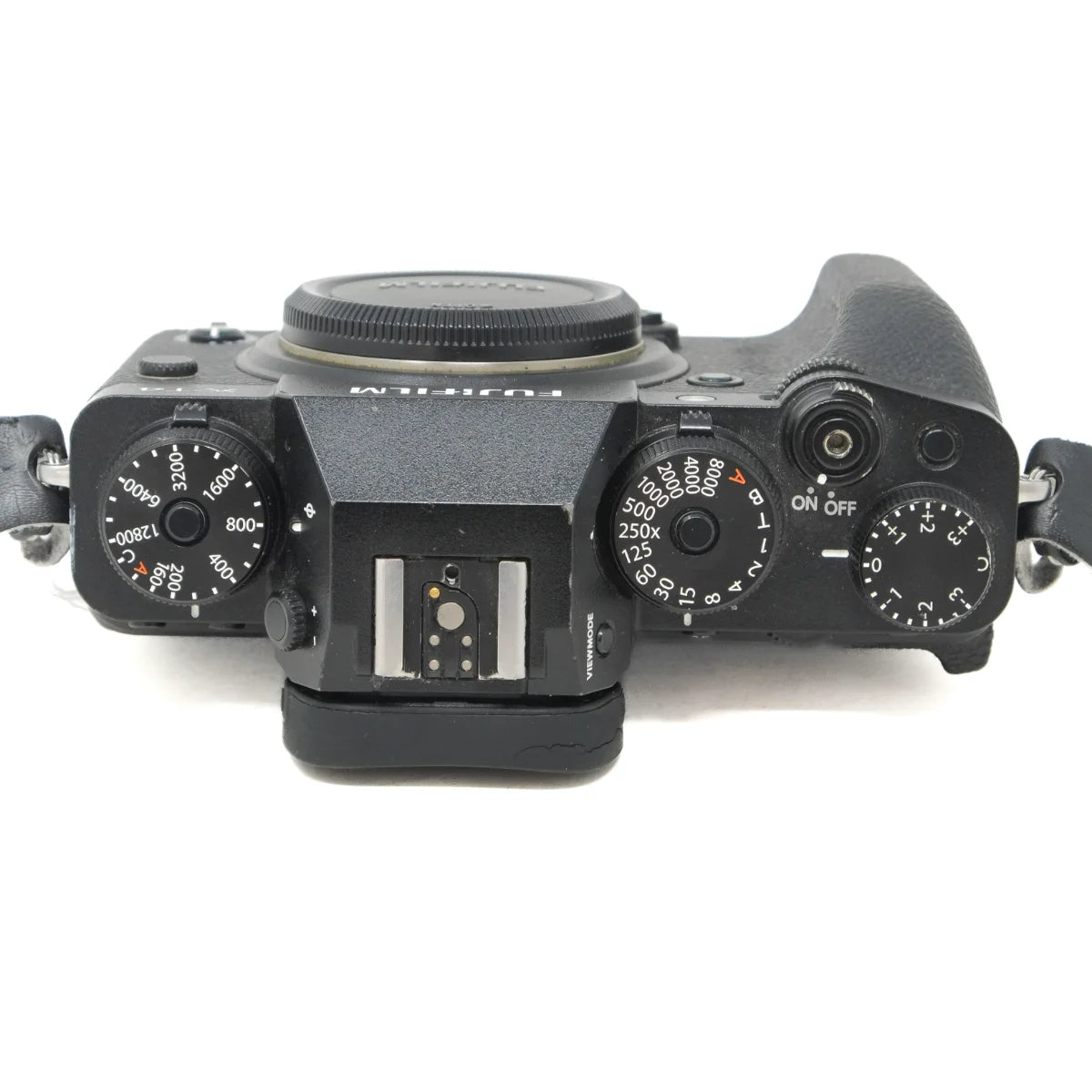 A black Fujifilm mirrorless camera body photographed from a top-down angle on a plain white background.