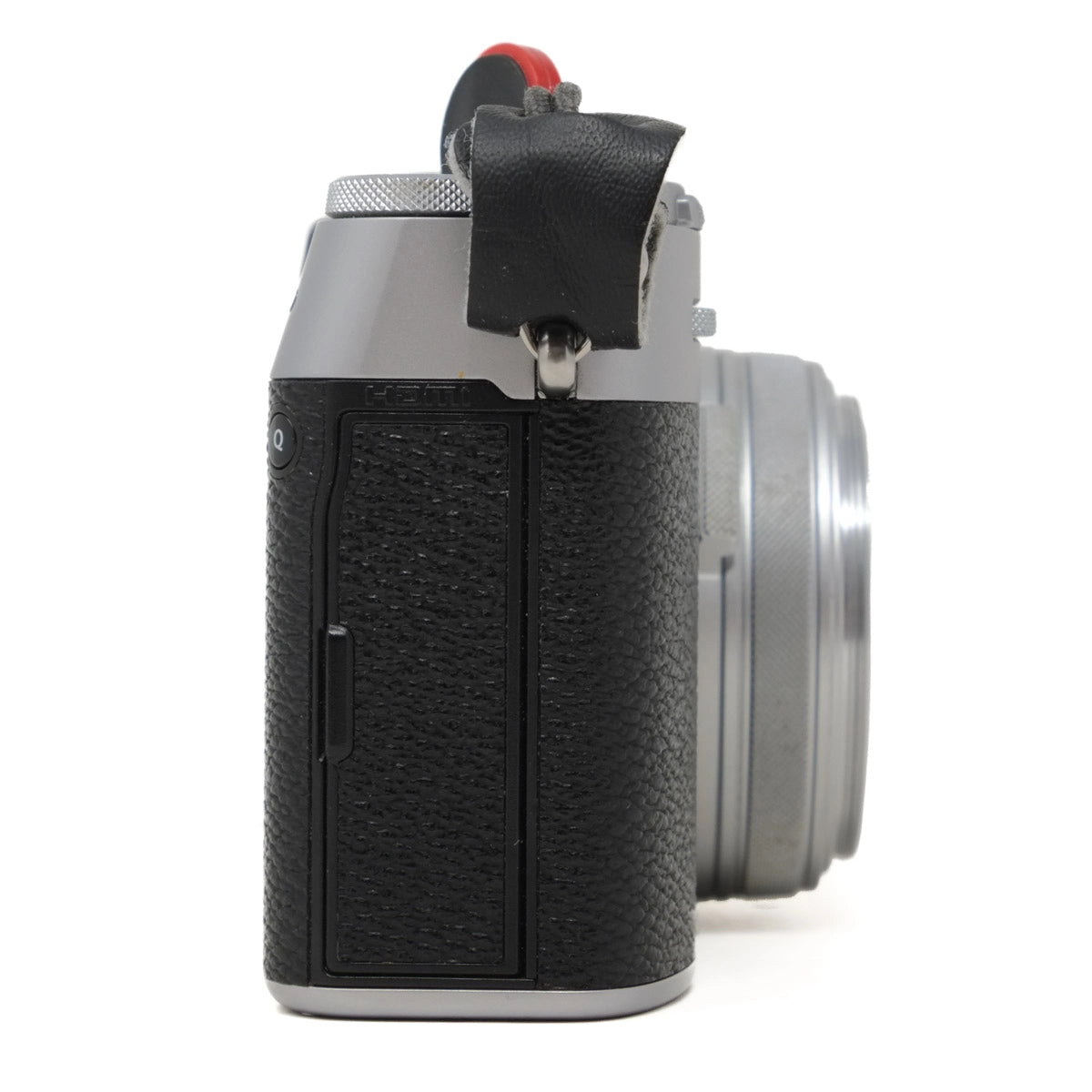 Camera body with lens on a white background