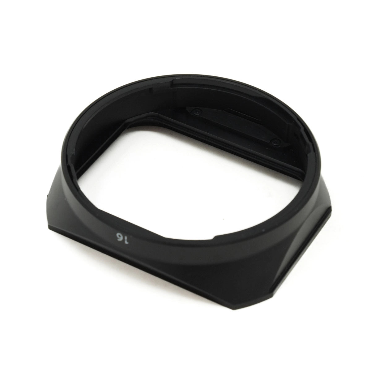 Black camera lens hood on a white background