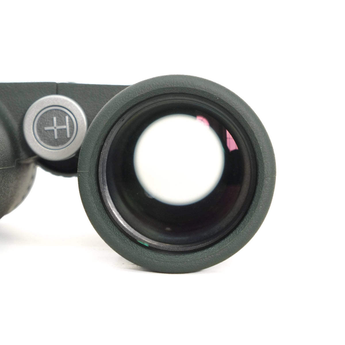 Close-up of a binocular lens with a white background