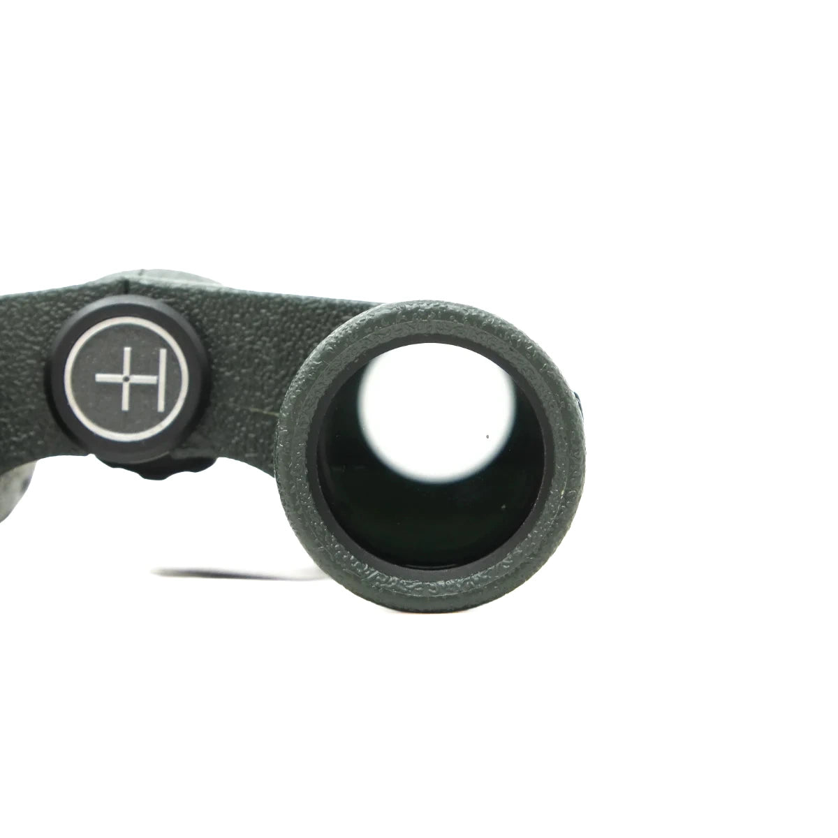 Close-up of a dark green textured binocular eyepiece showing the objective lens and a black adjustment knob with a white cross symbol, set against a plain white background.