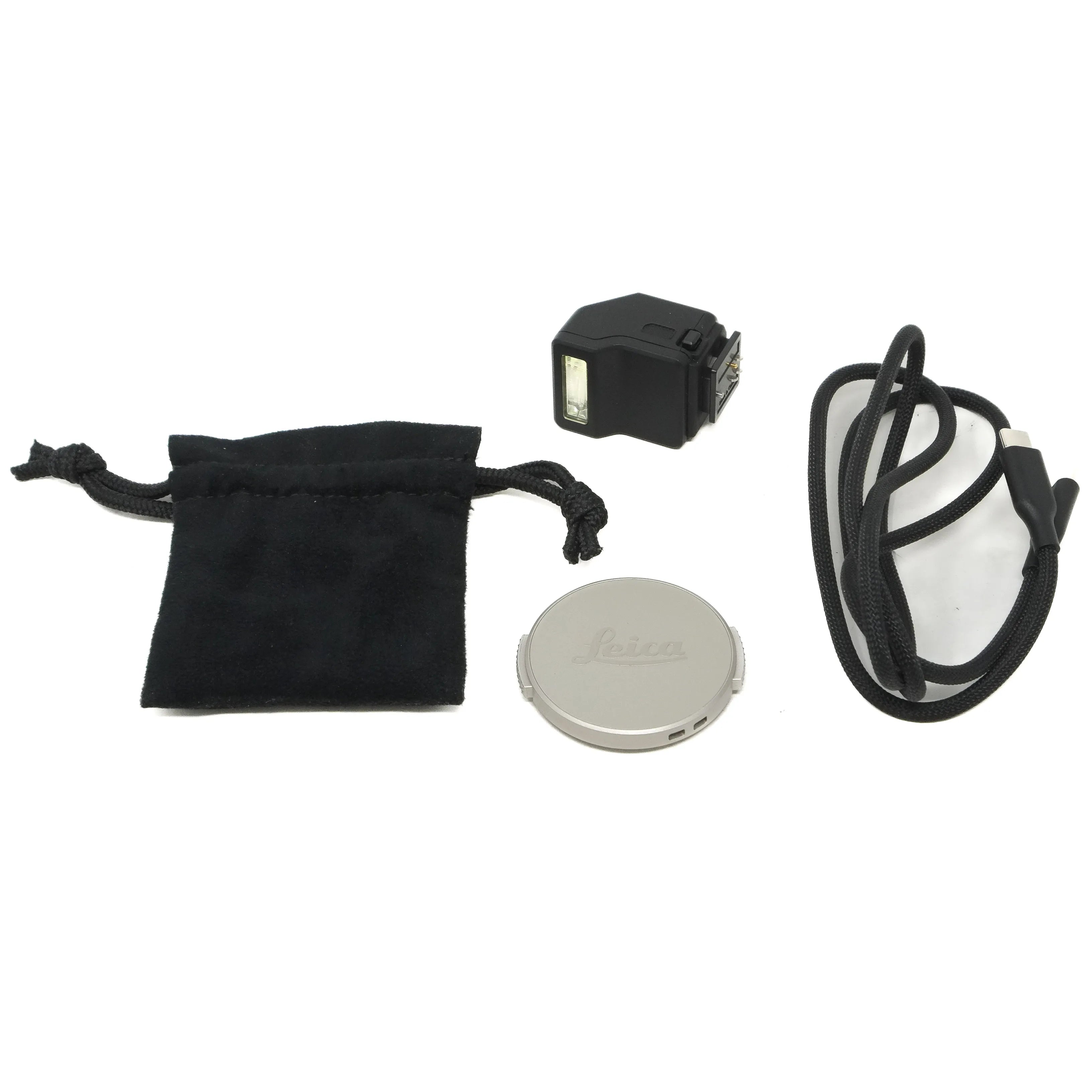 Collection of photography accessories including a lens cap, flash, and cable on a white background