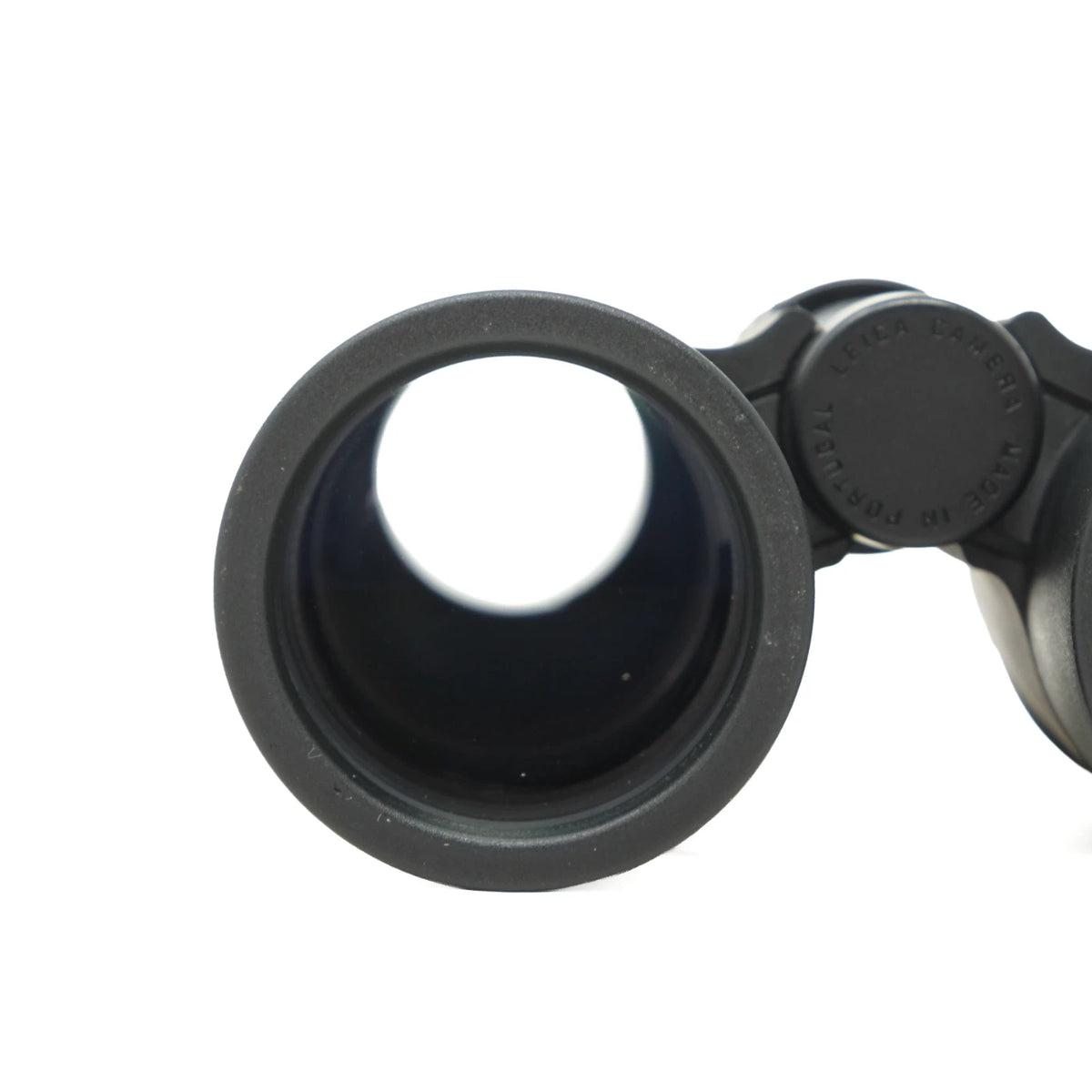Close-up of a black binocular eyepiece and hinge on a plain white background.