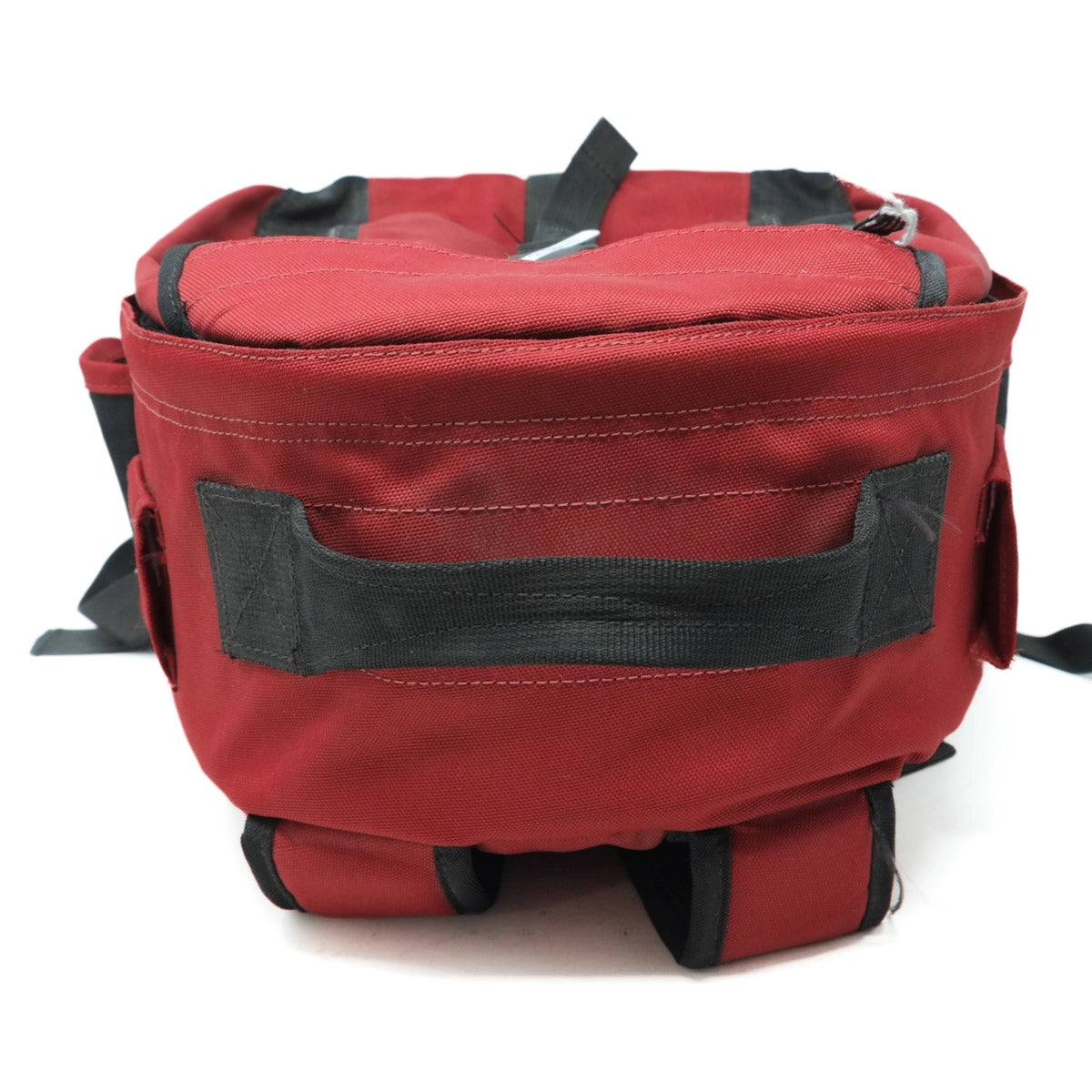 Red backpack with black straps on a white background