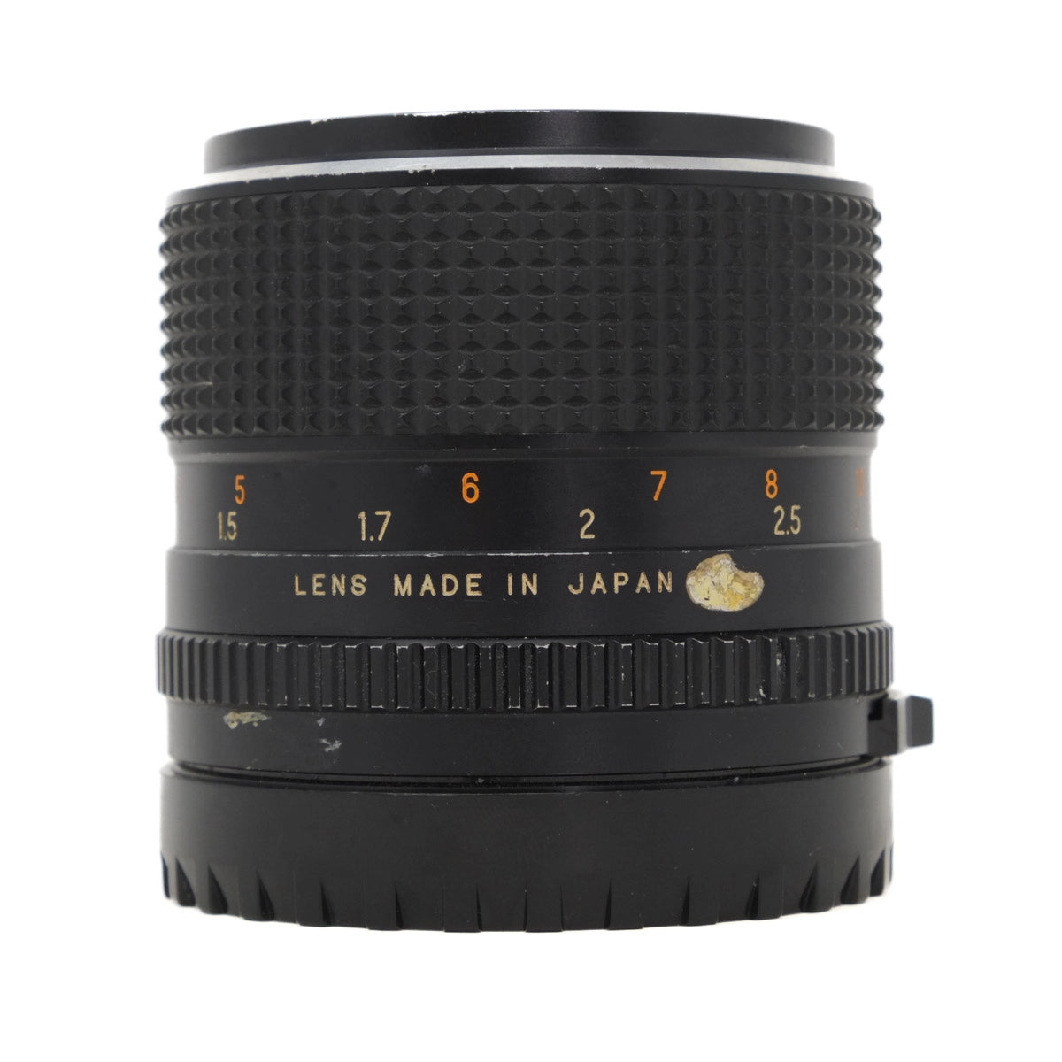 Camera lens with 'Lens Made in Japan' text on a white background