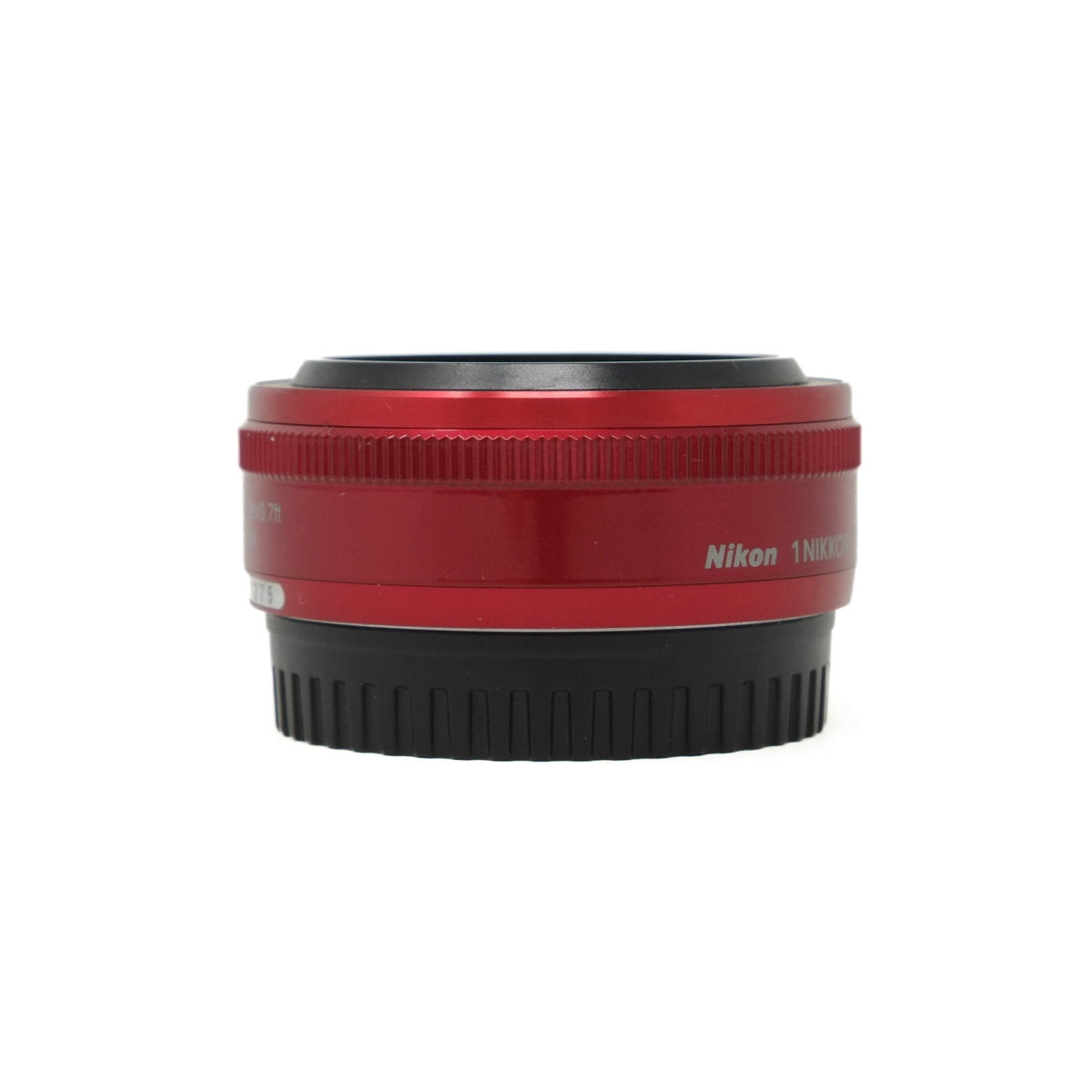 Red camera lens with black base on a white background