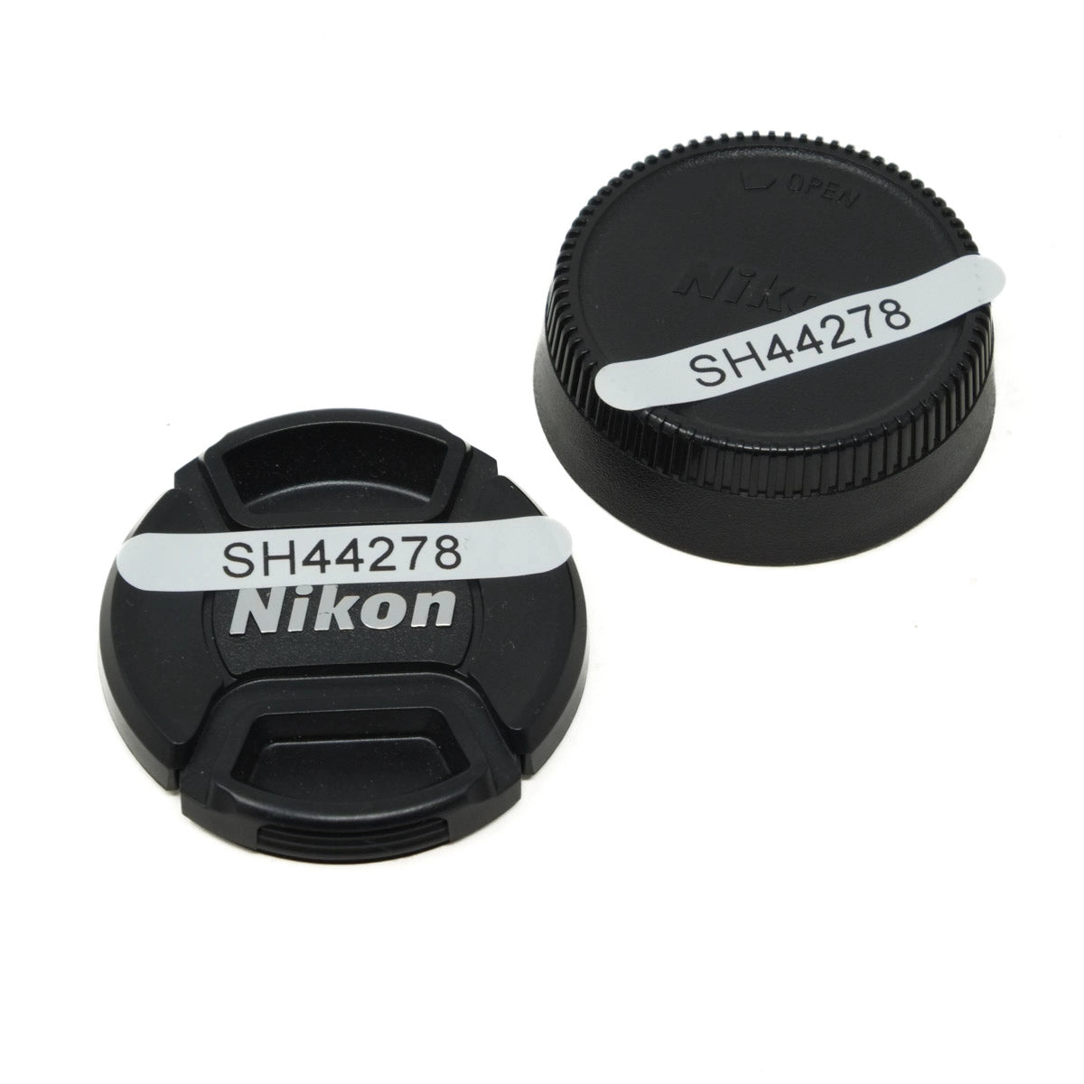 Two Nikon lens caps with 'SH44278' label on a white background