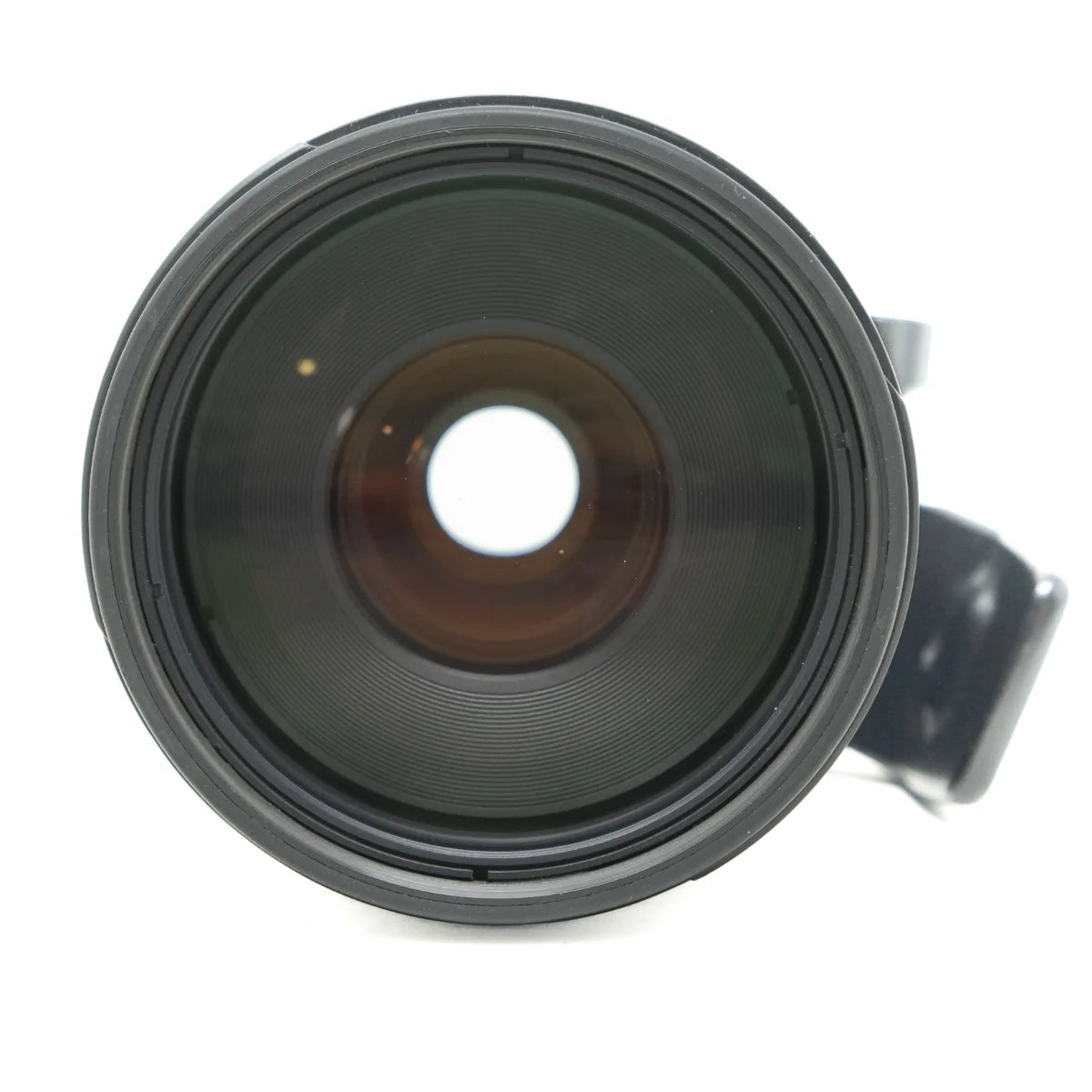 A close-up shot of a black camera lens with a dark glass lens element and a small portion of a black mount visible on the right, set against a plain white background.