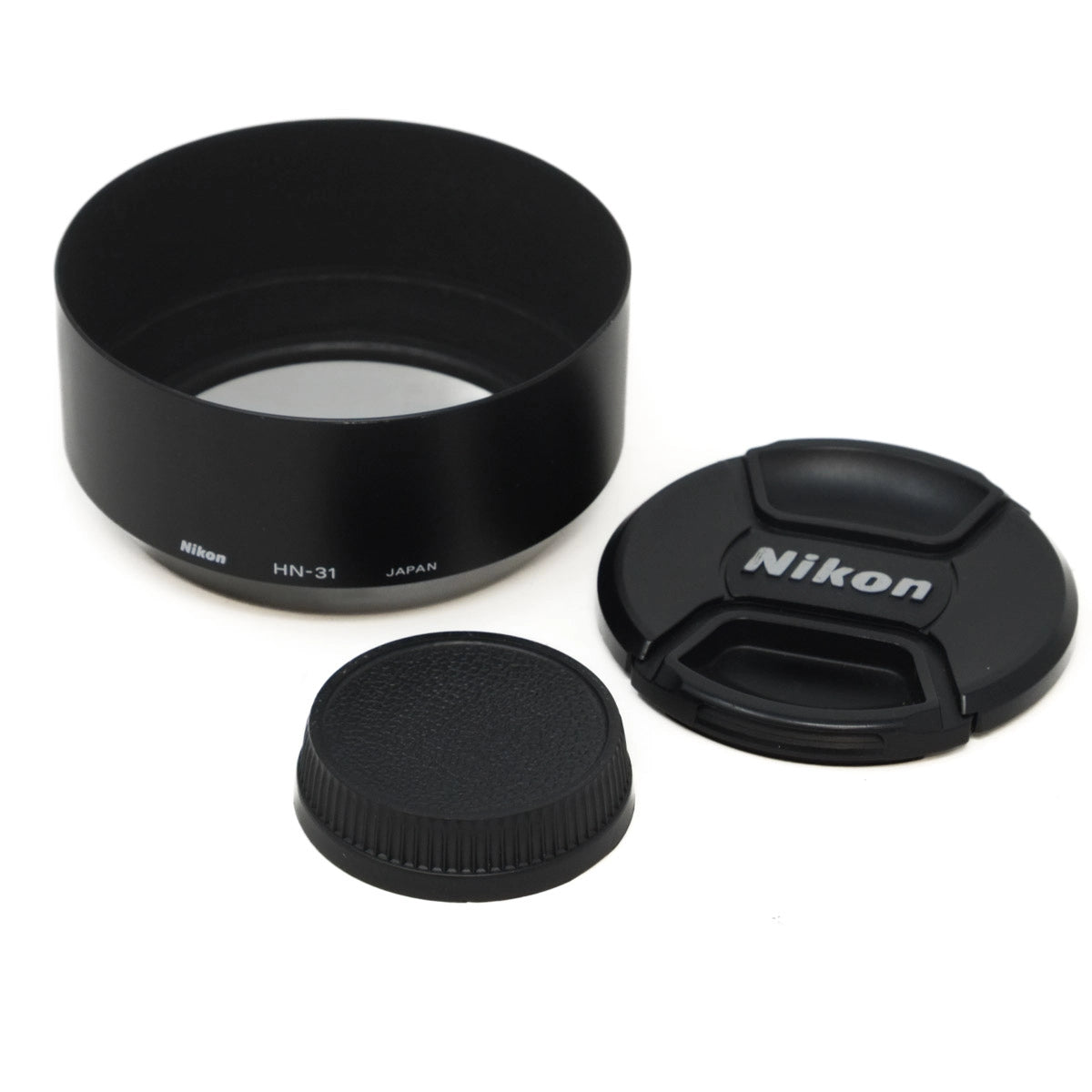 Nikon lens hood and cap set on a white background