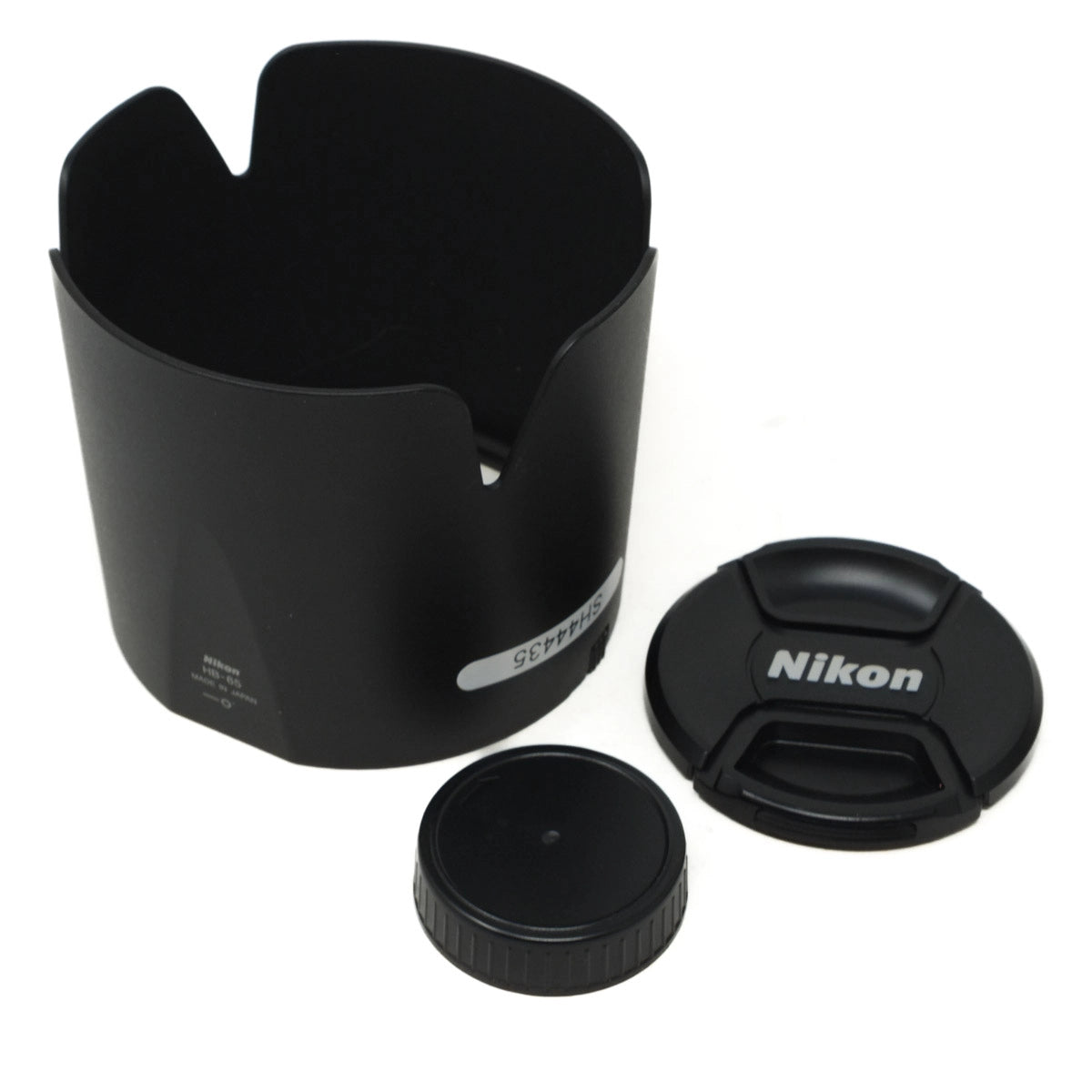 Camera lens hood and cap with Nikon logo on a white background