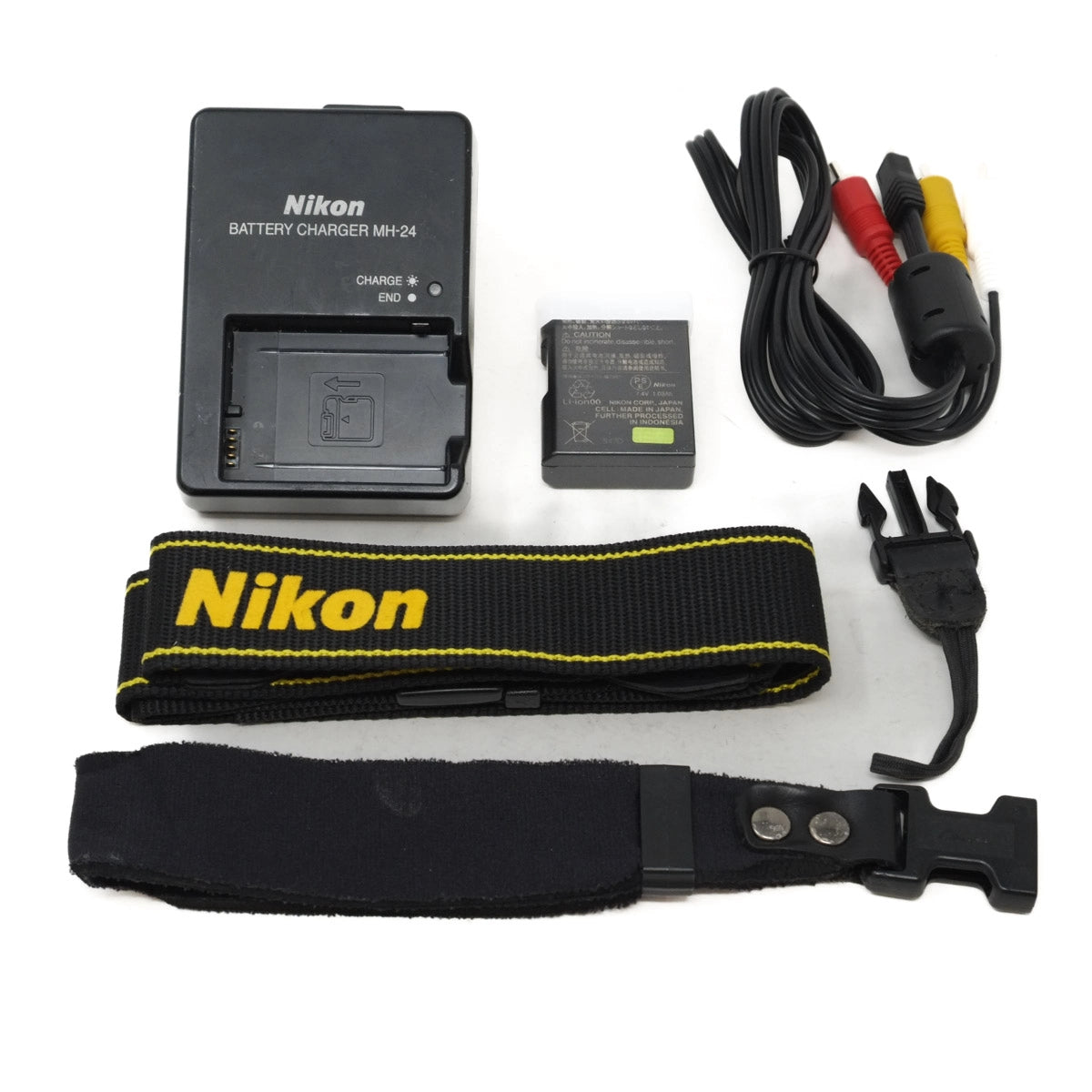 Nikon camera battery charger, battery, strap, and cable on a white background