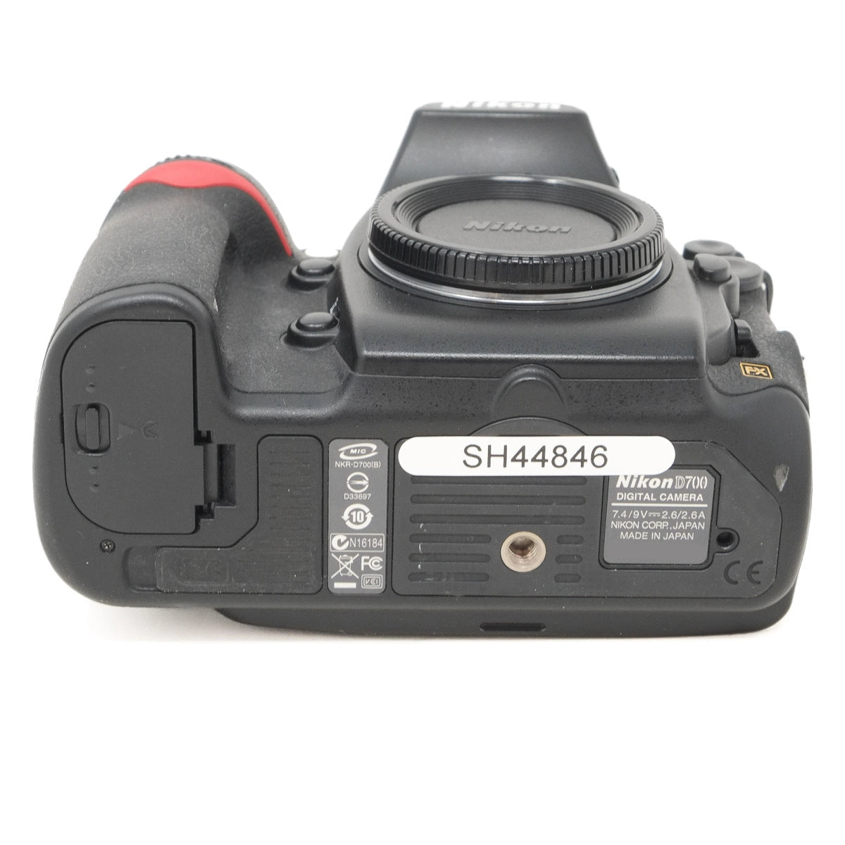 Bottom view of a Nikon camera on a white background