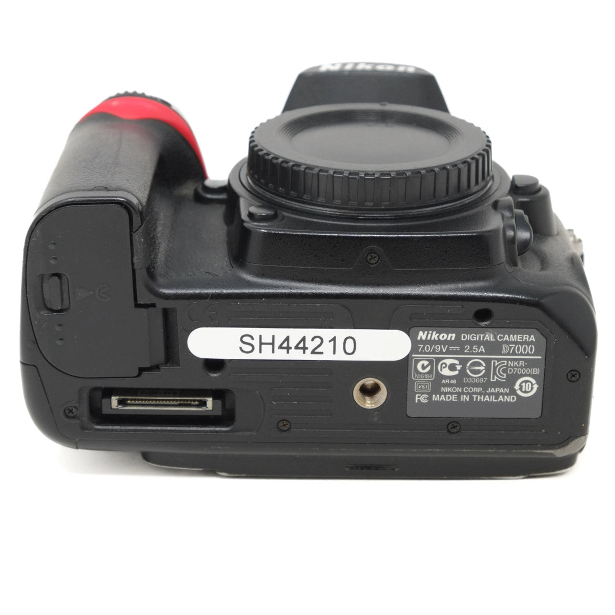 Bottom view of a Nikon digital camera on a white background