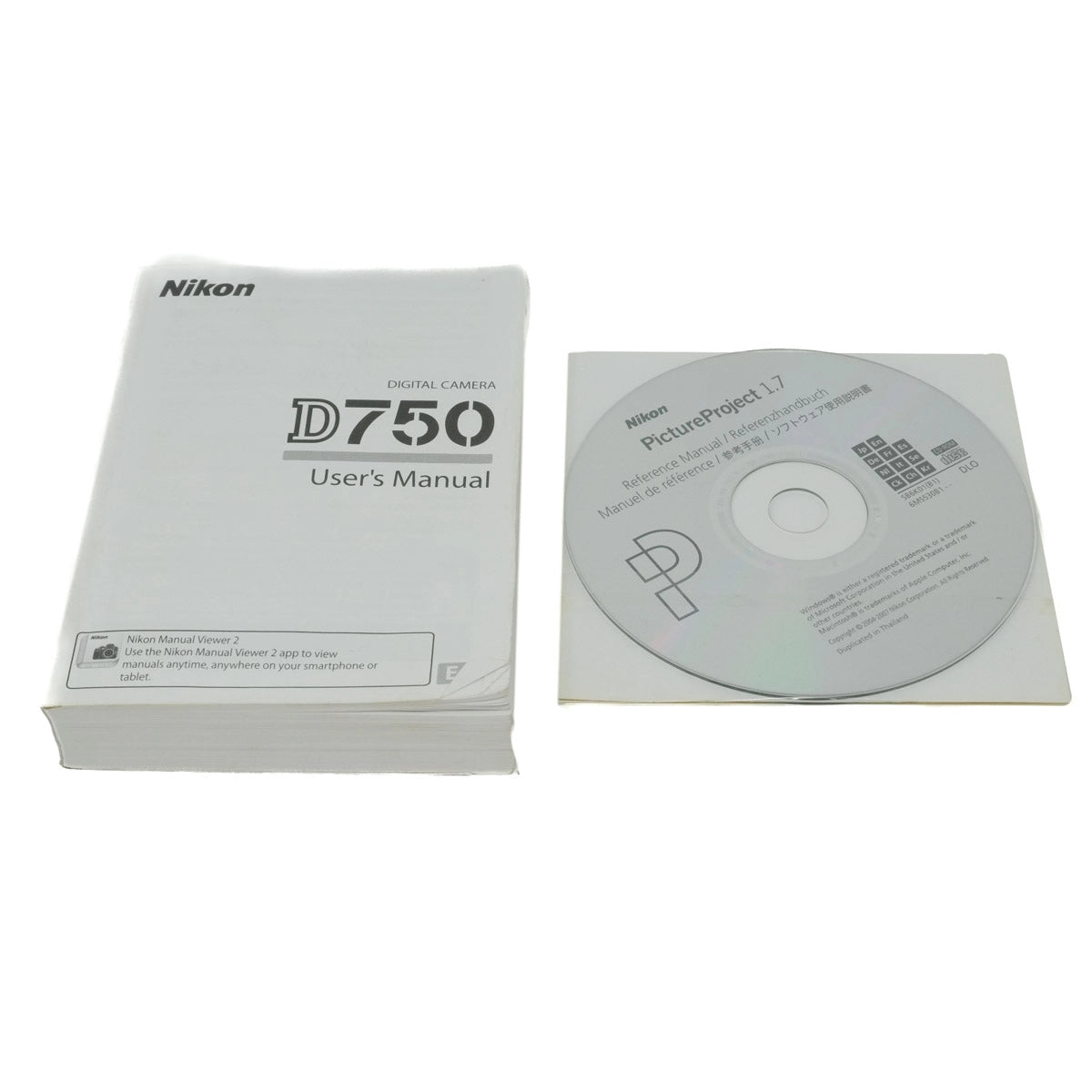 Nikon D750 user's manual and PictureProject software CD on a white background