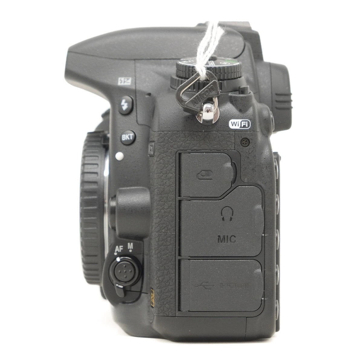 Side view of a black camera body with control buttons on a white background